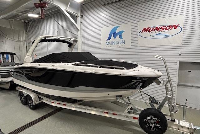 2026 Chaparral SSX 8 boat on trailer in showroom with Munson signage.
