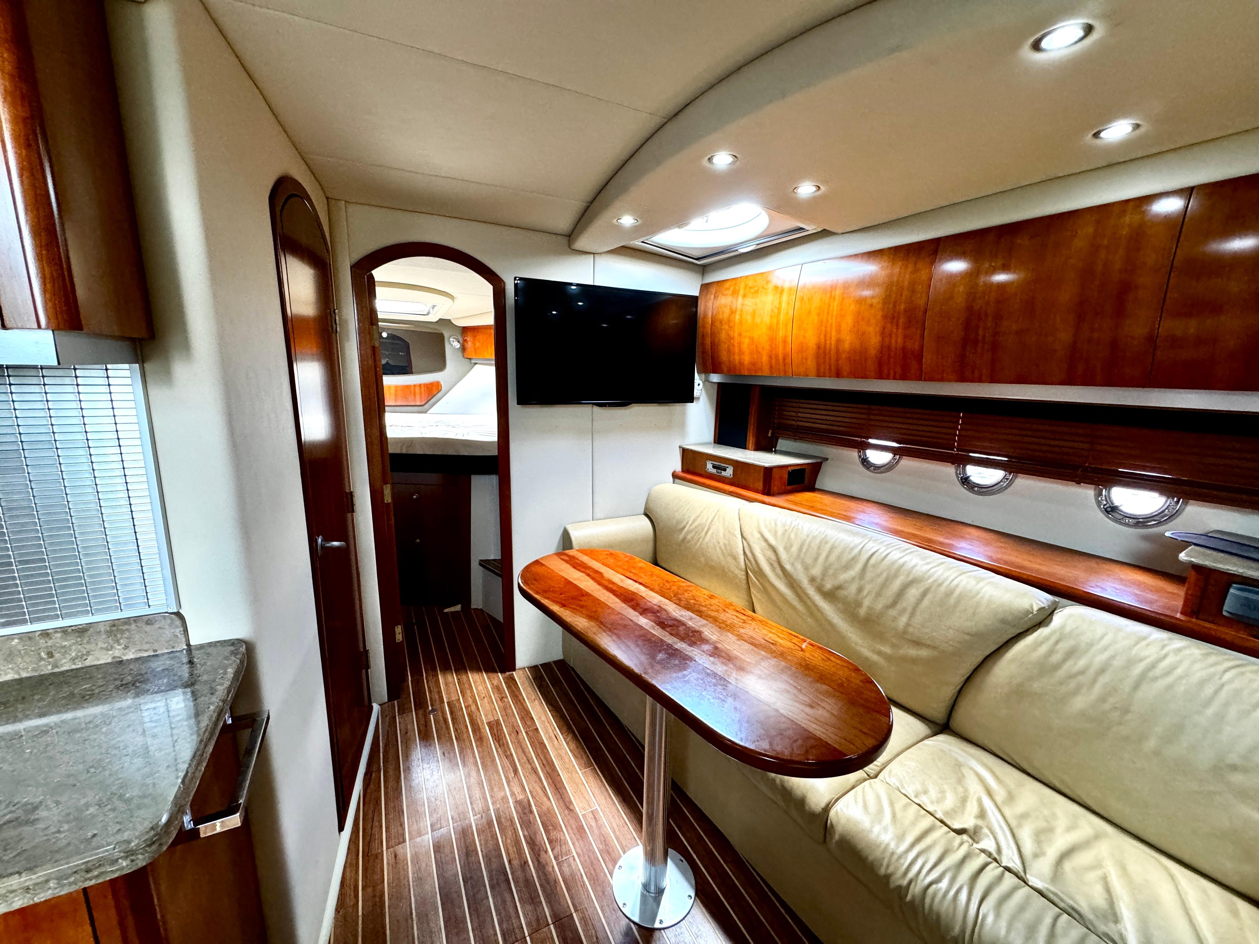 Luxurious interior of 2008 Cruisers Yachts 390 Sports Coupe with wood finishes and modern amenities.