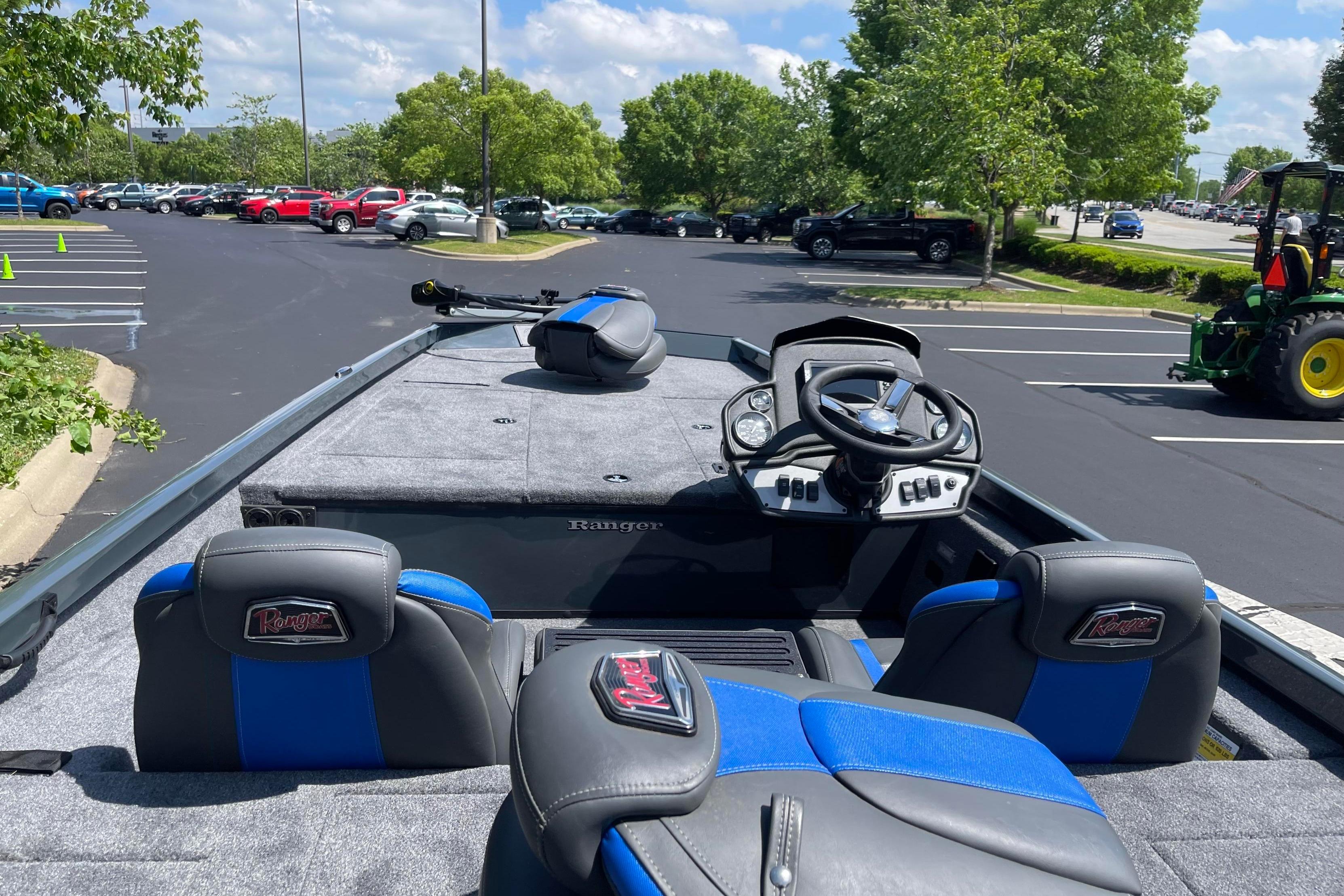 2026 Ranger RT188 boat interior with steering wheel and seats in parking lot.