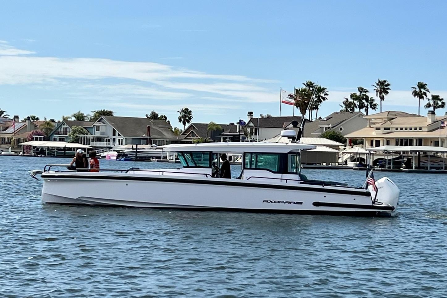 2022 Axopar Brabus 37 XC Cross Cabin boat on a scenic waterfront.