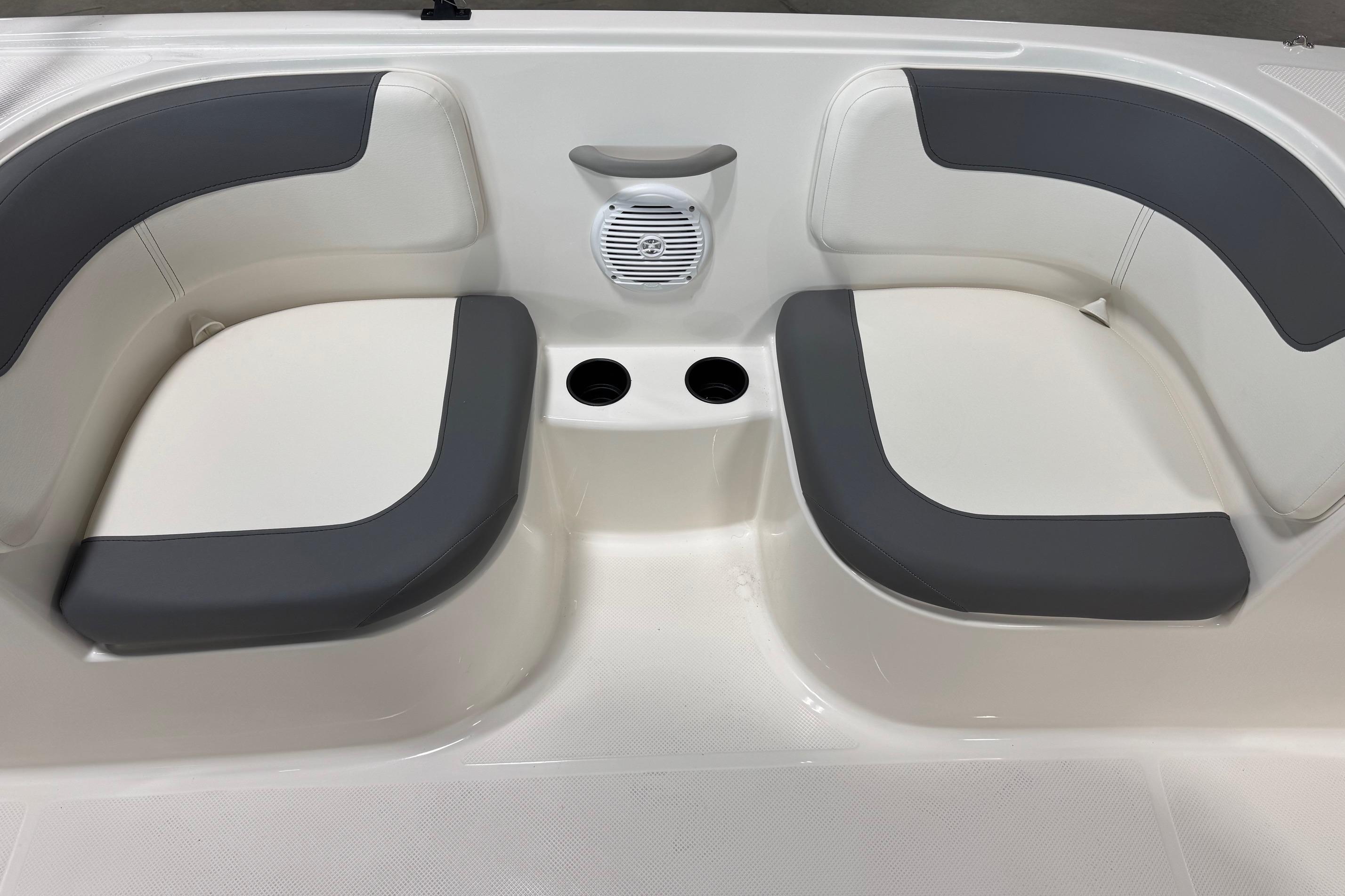 2026 Bayliner Element E18 boat interior with cushioned seating and cup holders.