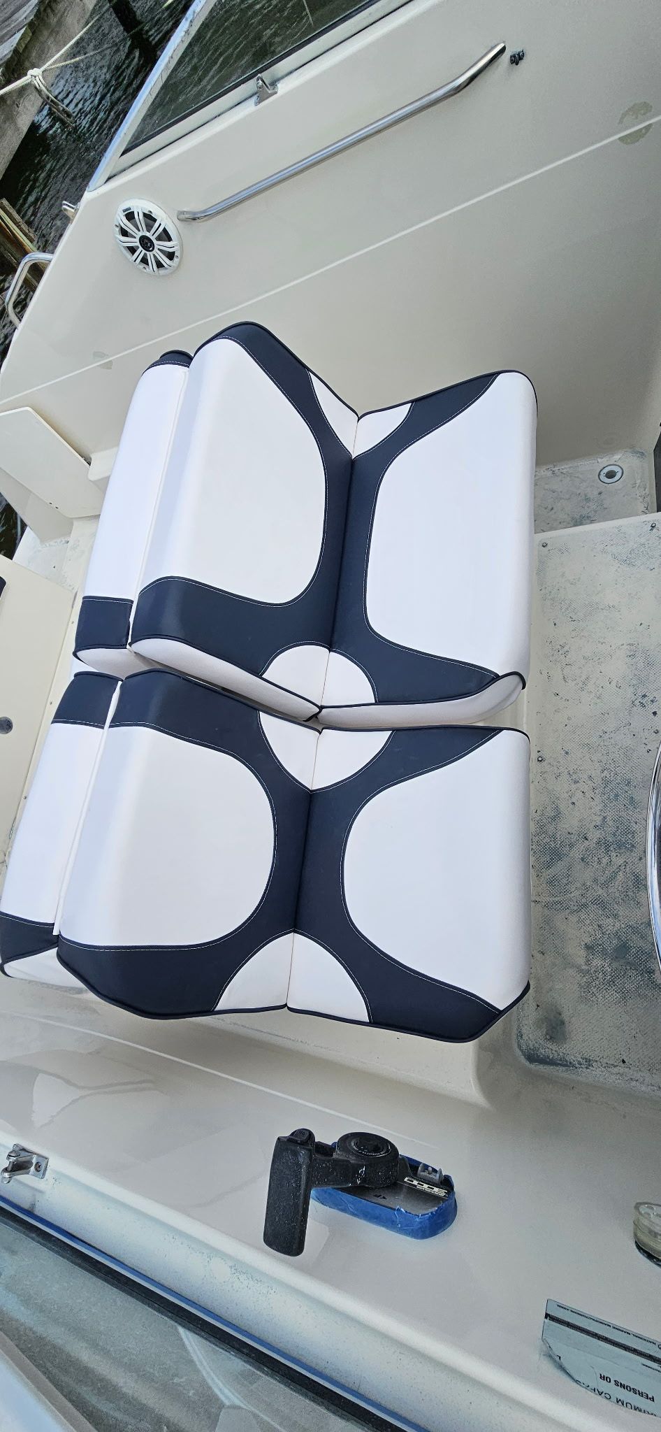 A stylish seat with black and white upholstery on a boat.