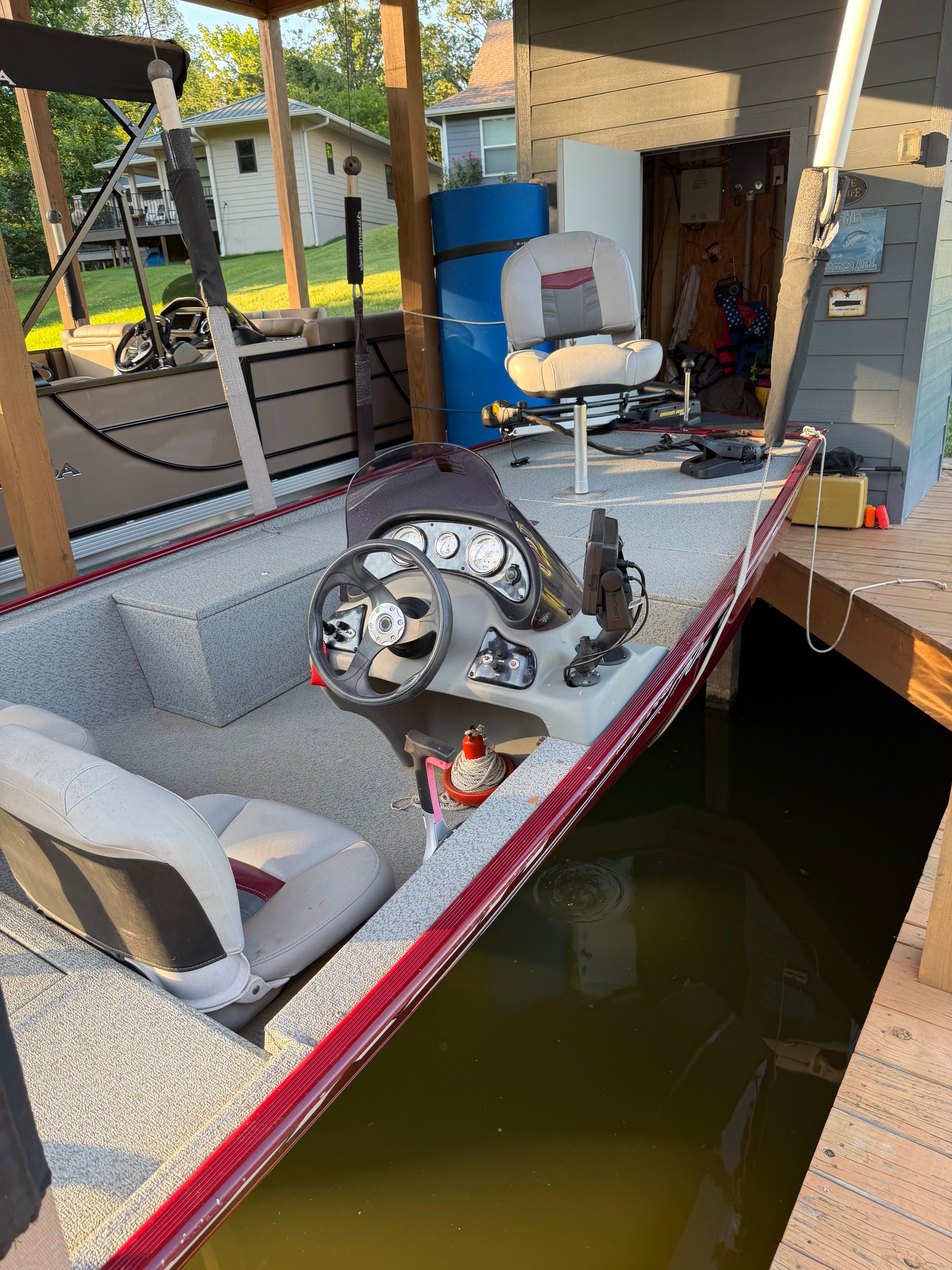 A 2017 Bass Tracker Pro 170 at a dock. Visible are the steering console and seats.