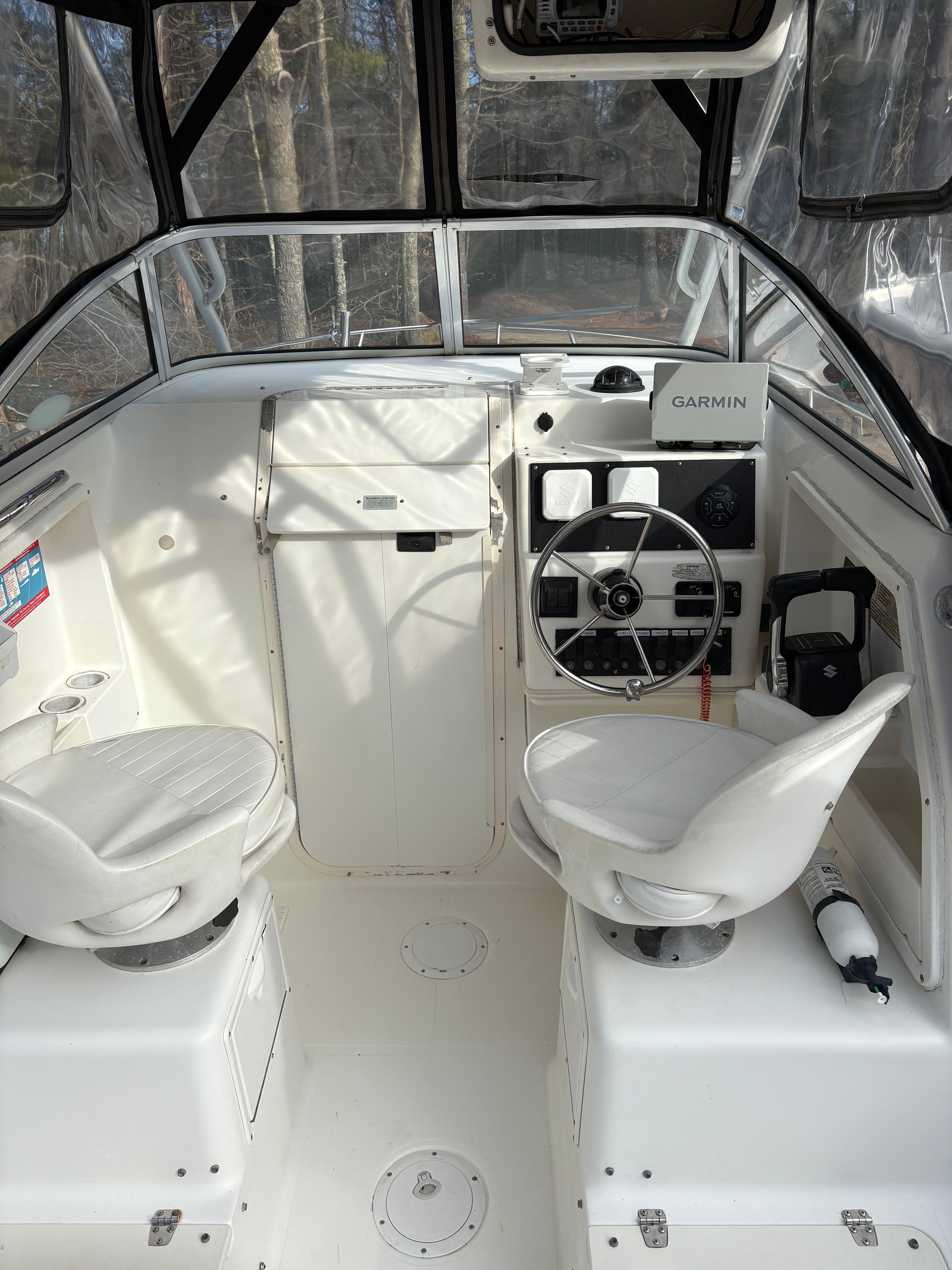 Interior of a 2000 Spacecraft Cuddy with steering wheel and seats.