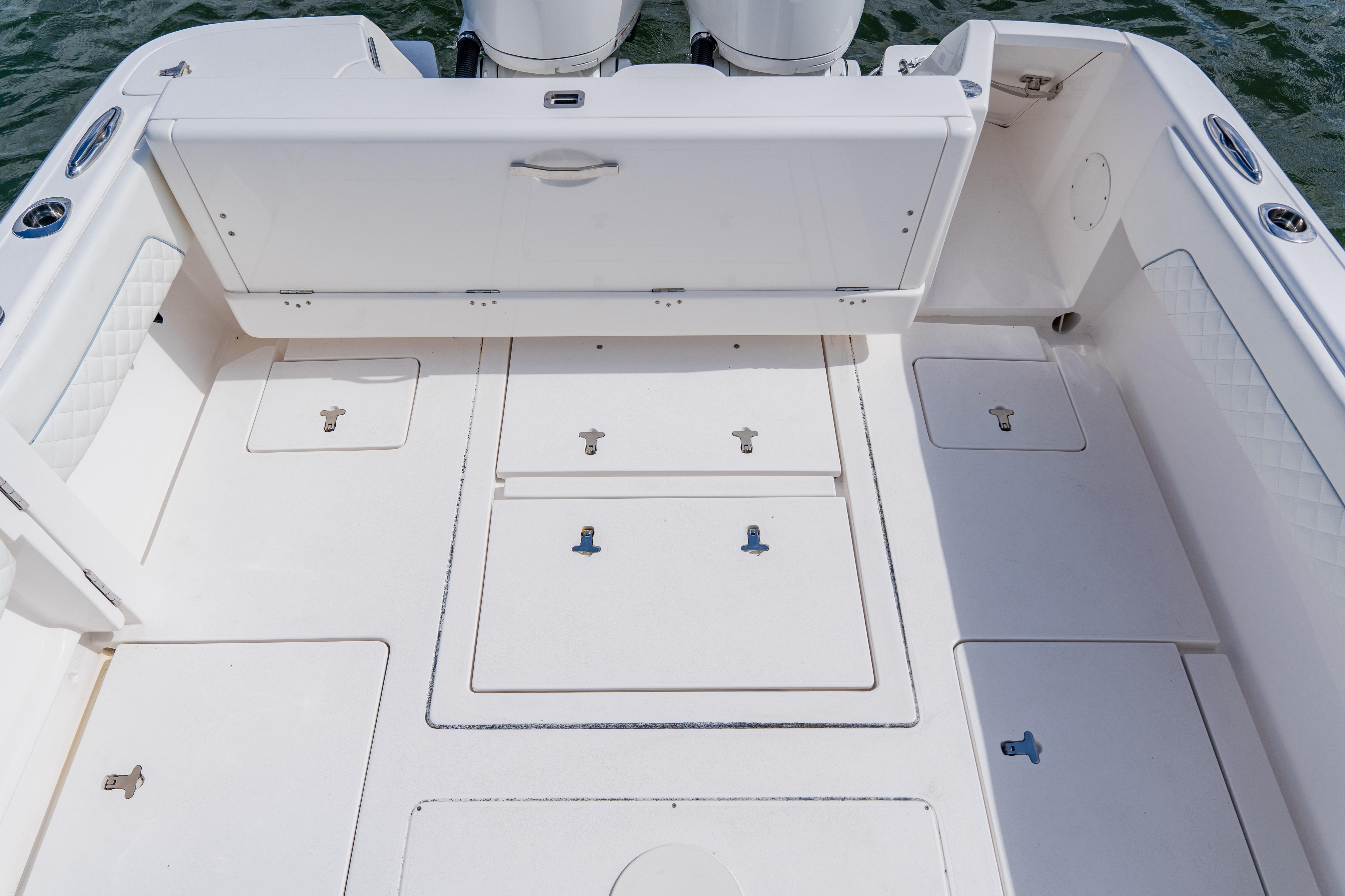 2018 Intrepid 327 Center Console boat deck with storage compartments and seating.