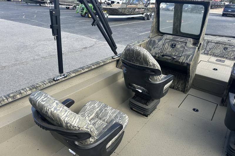 2025 SeaArk Predator 300 AK boat interior with camo seats and steering console.