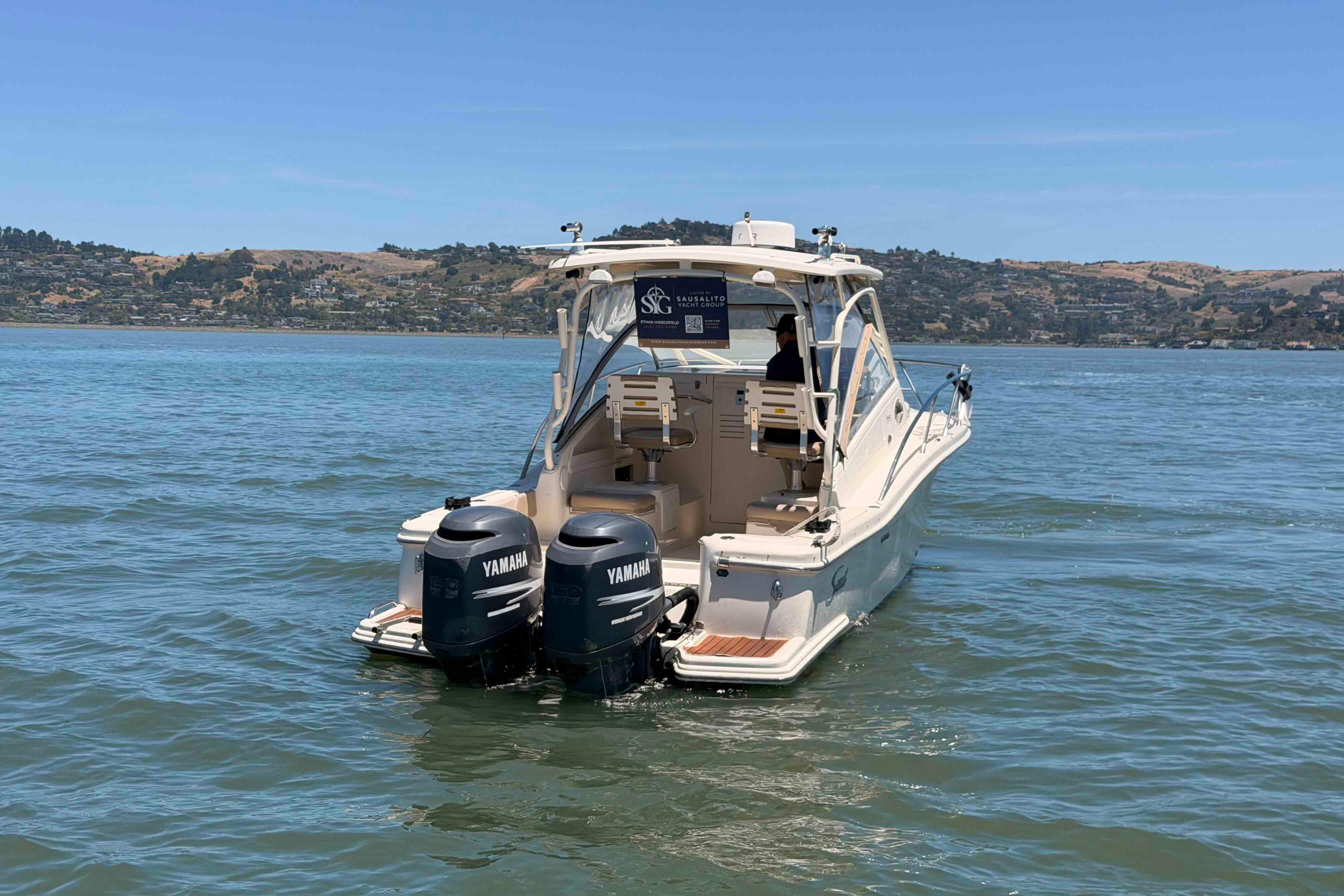 2007 Scout 262 Abaco boat with twin Yamaha engines on a calm lake.
