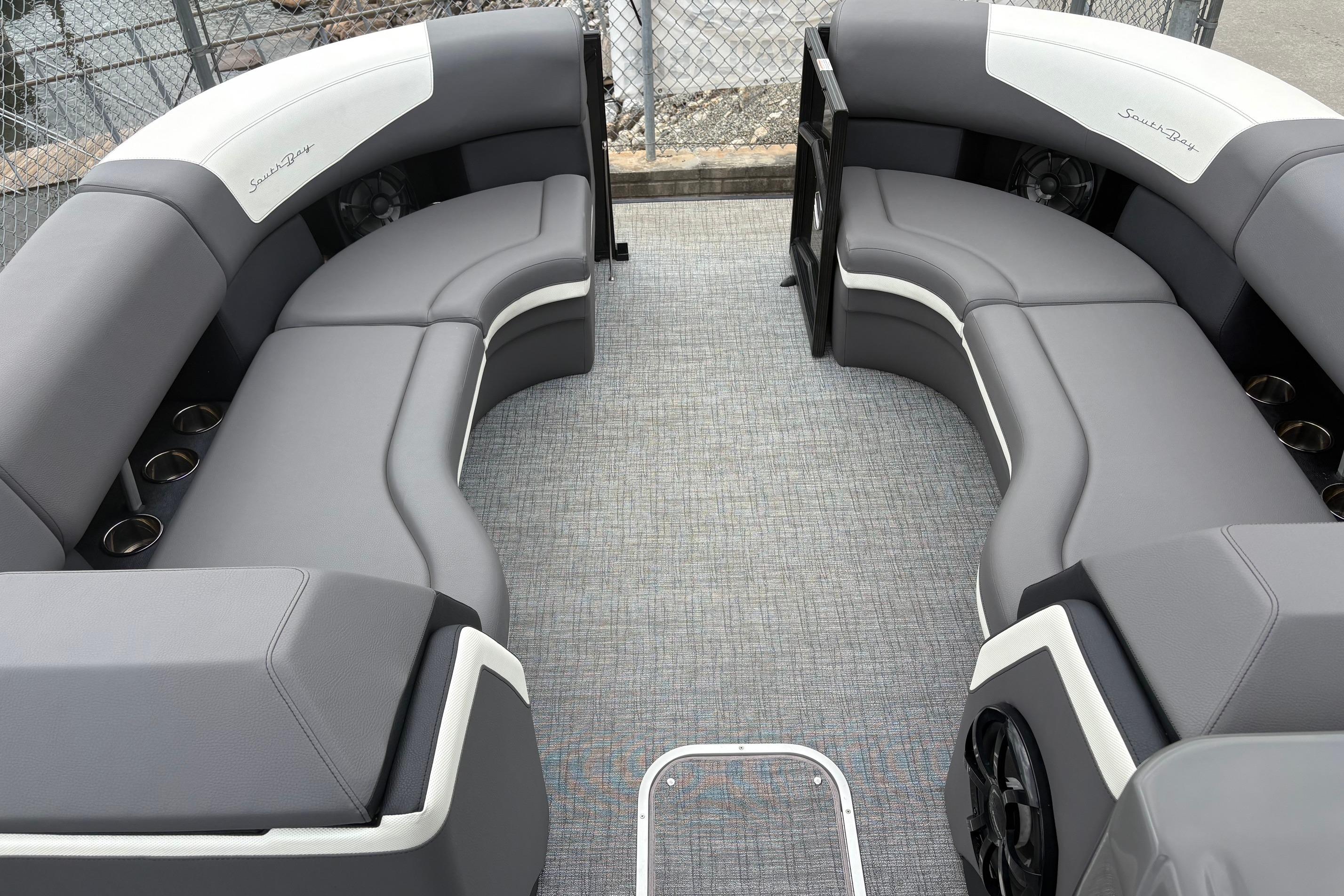 2023 South Bay 525 RS 3.0 Arch pontoon boat with gray seating and cup holders.