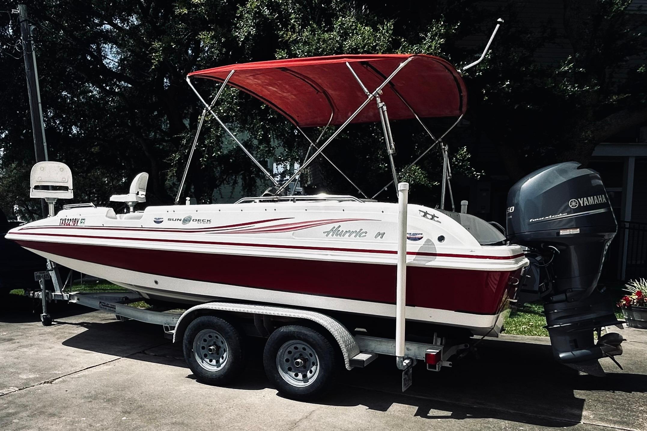 2013 Hurricane SunDeck Sport 201 OB boat with Yamaha outboard motor on trailer.