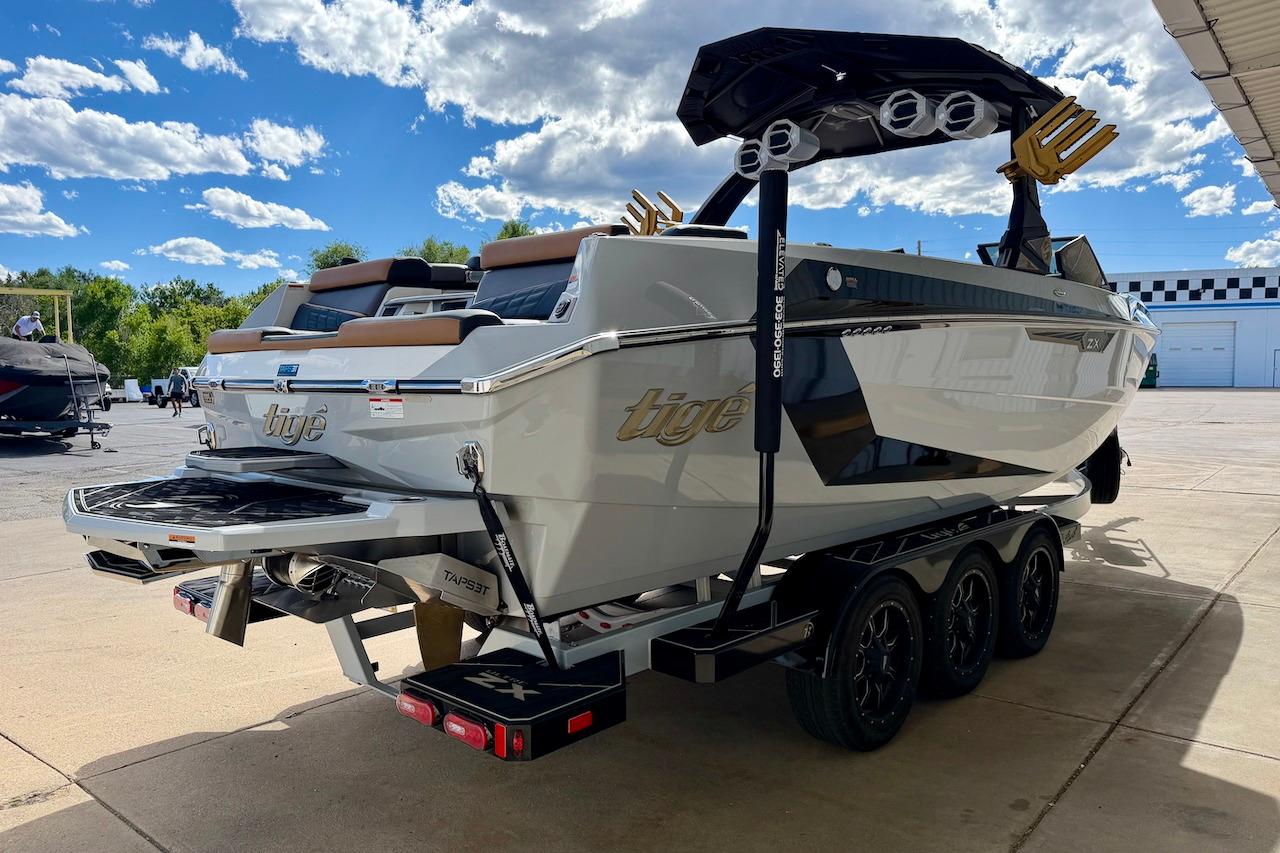 2025 Tigé Ultré 25ZX boat on trailer, sleek design, sunny day, outdoor setting.