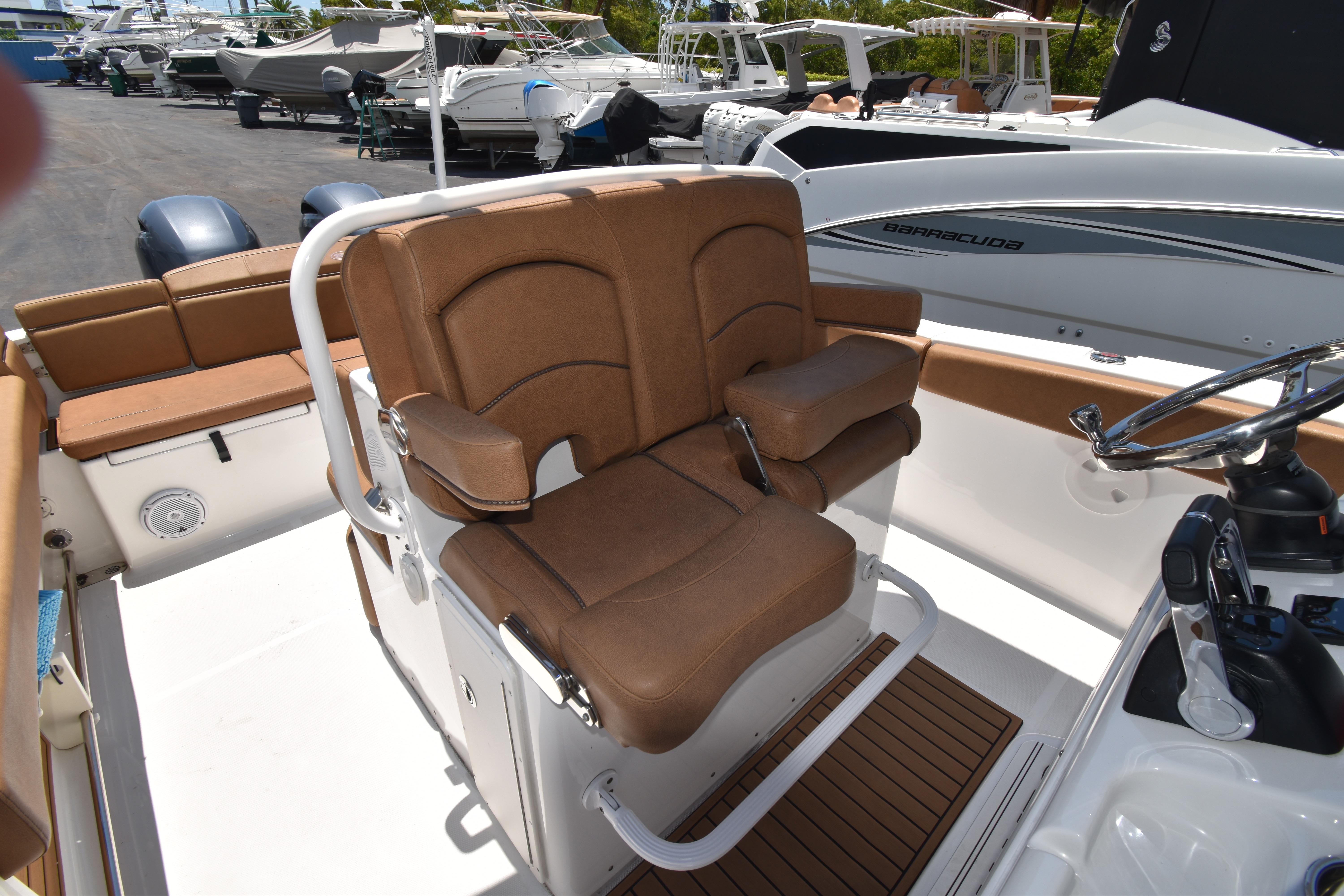 2020 Sea Hunt Ultra 275 SE boat interior with brown seating and steering console.
