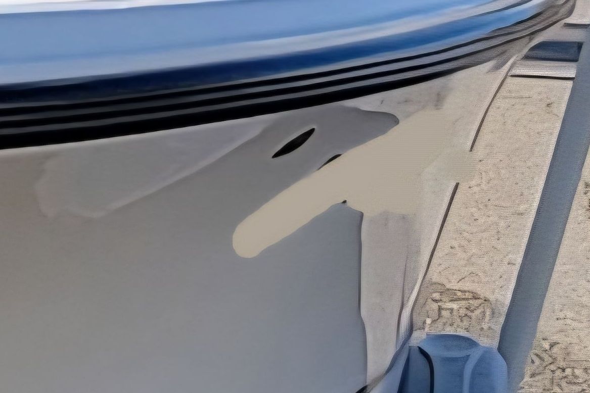 Close-up of the hull of a Mako 184 Center Console boat on a trailer.