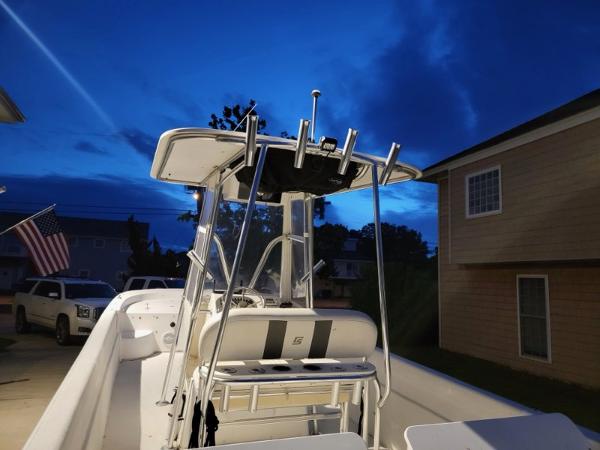 2011 Carolina Skiff 258 DLV boat at dusk, parked in residential driveway.