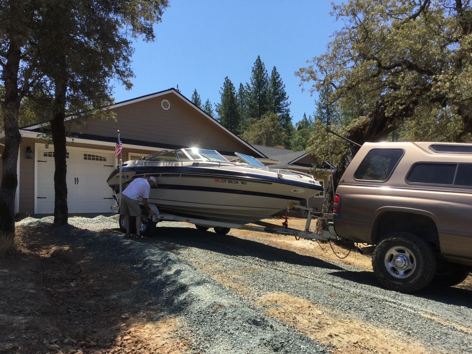 1996 Mariah Talari boat on trailer in front of house.