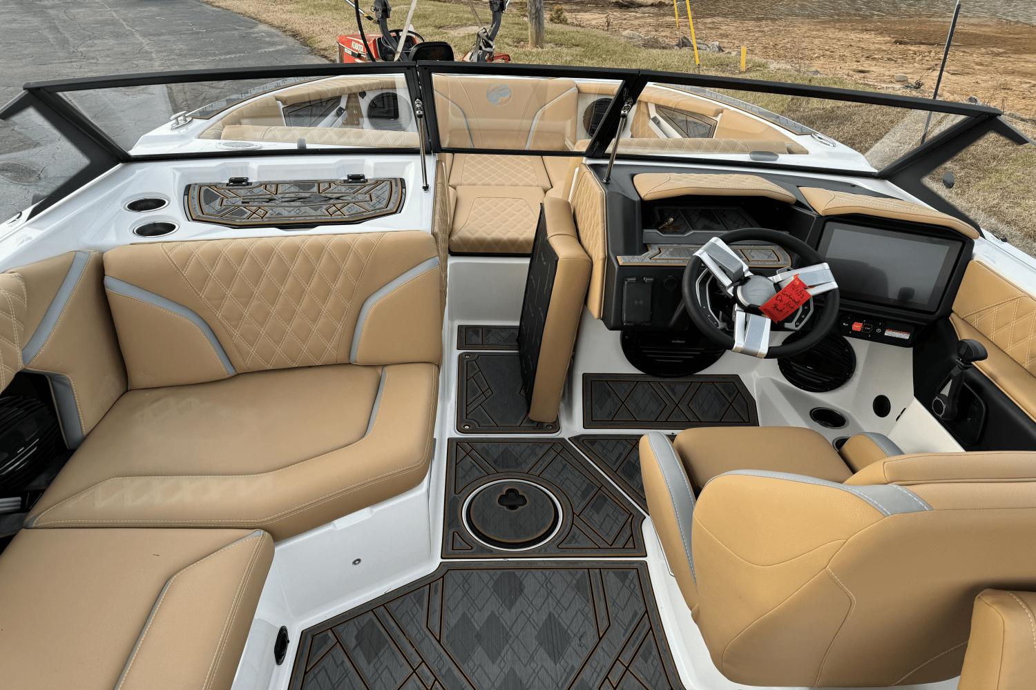 2024 Tigé RZX22 boat interior with tan leather seats and modern dashboard.