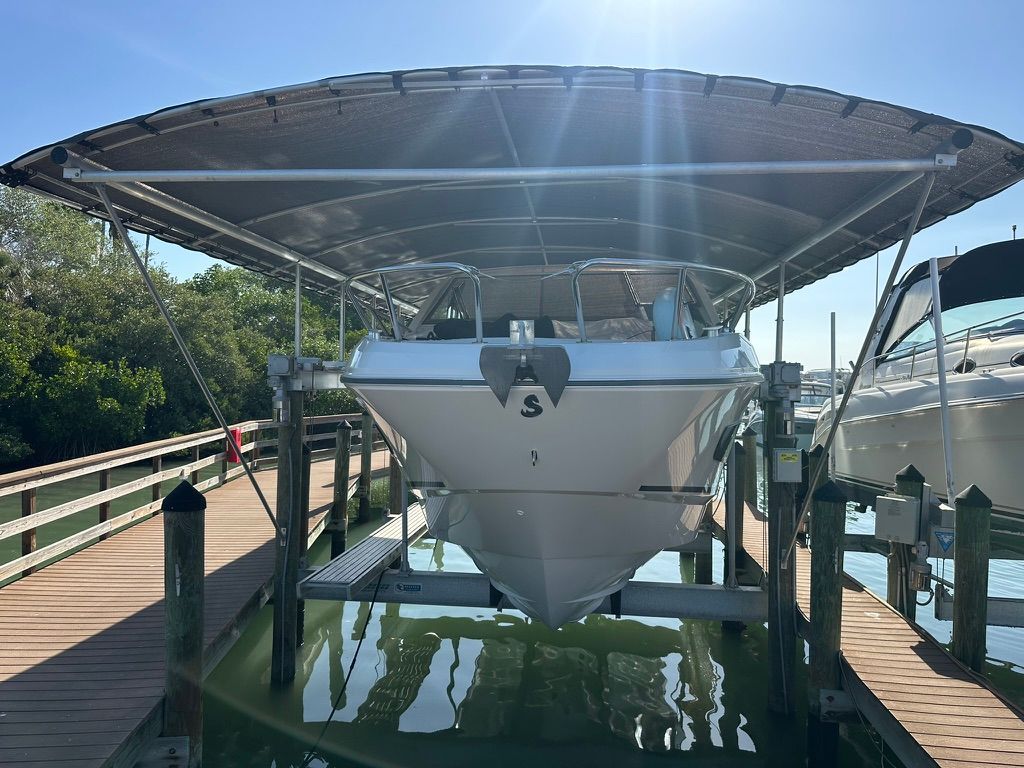 2024 Beneteau Gran Turismo 32 on boat lift under canopy.