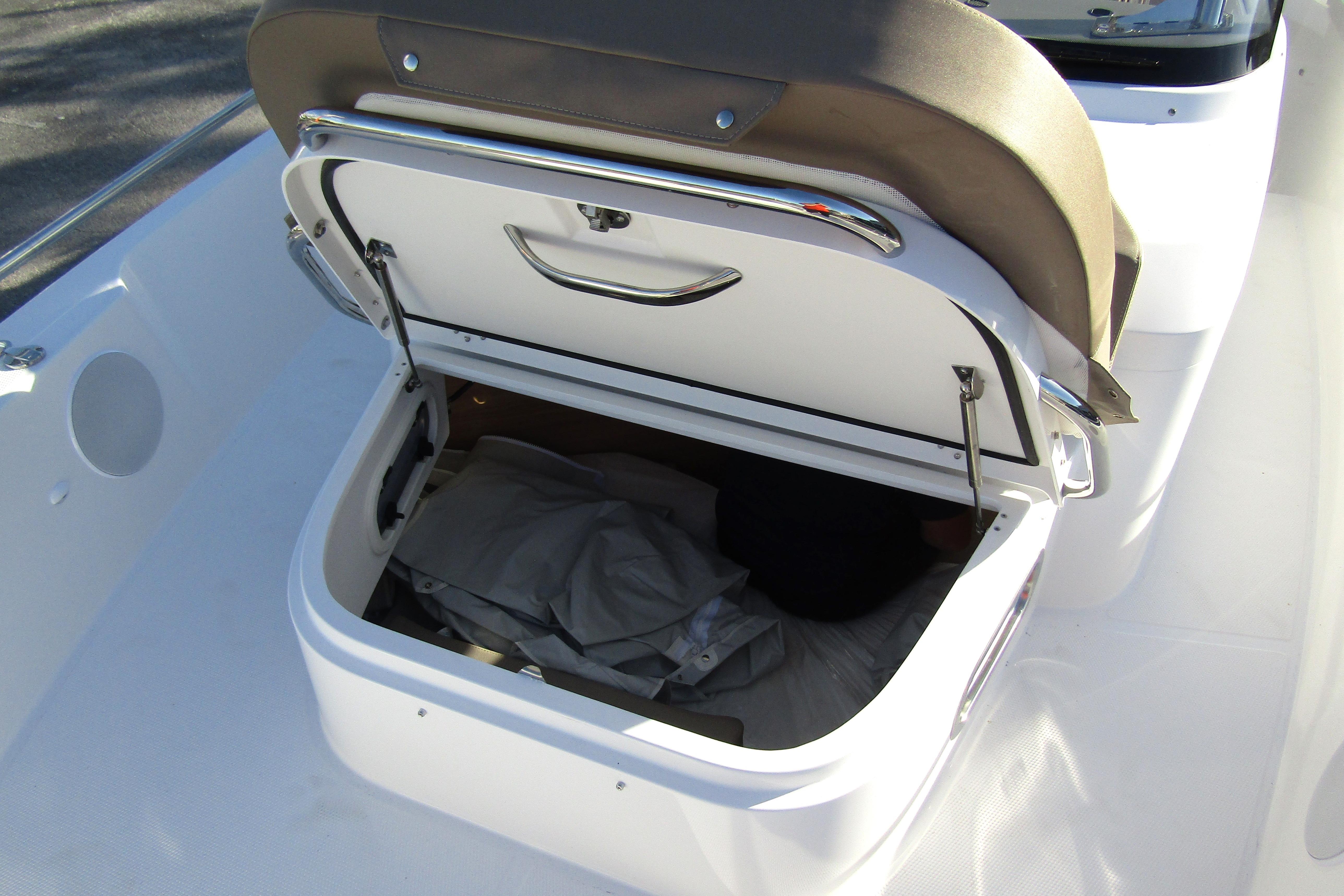 Open storage compartment on 2025 Nimbus Tender 9 boat, showcasing spacious interior.