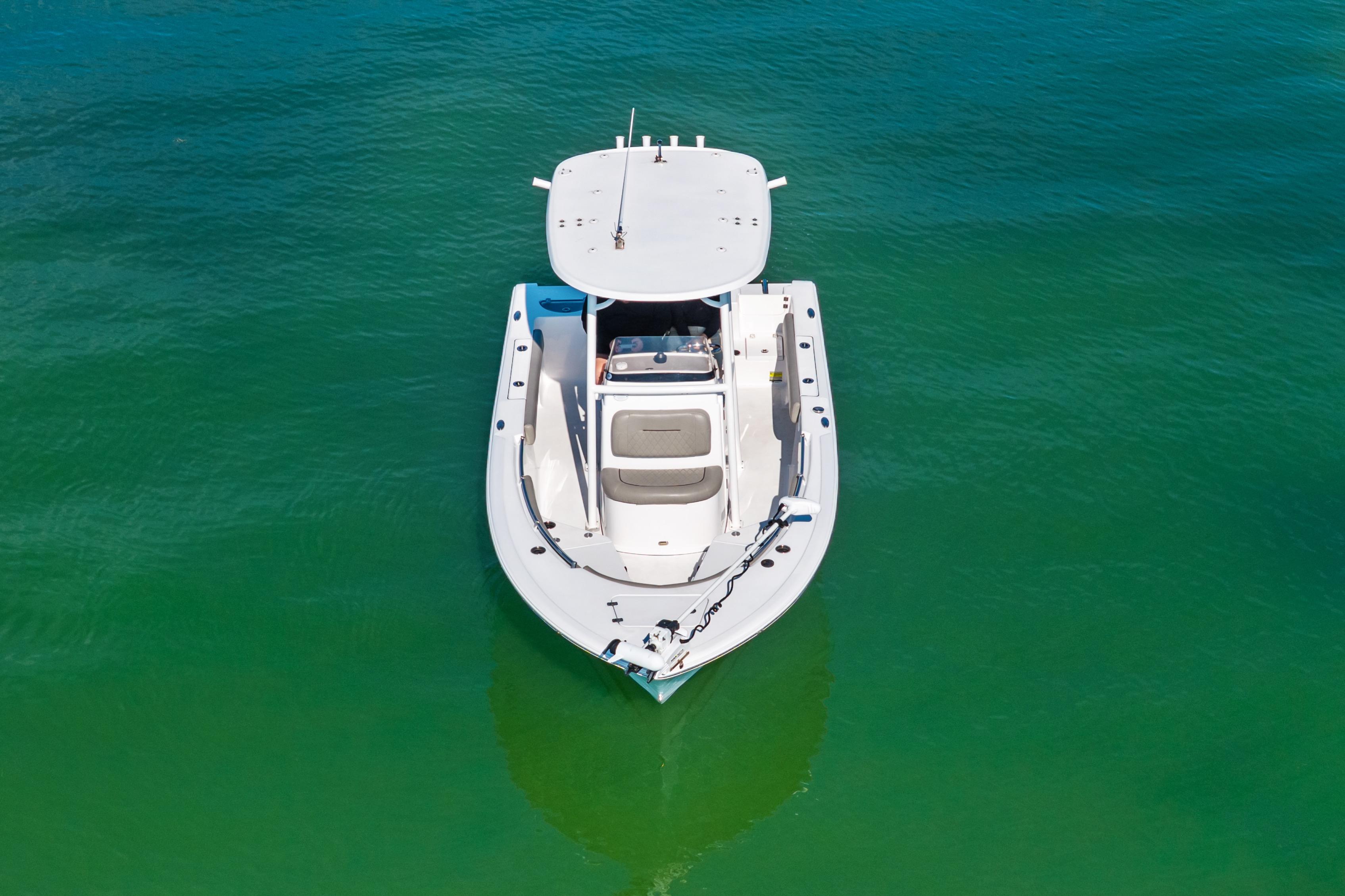 2021 Sportsman Open 212 Center Console boat on clear green water.