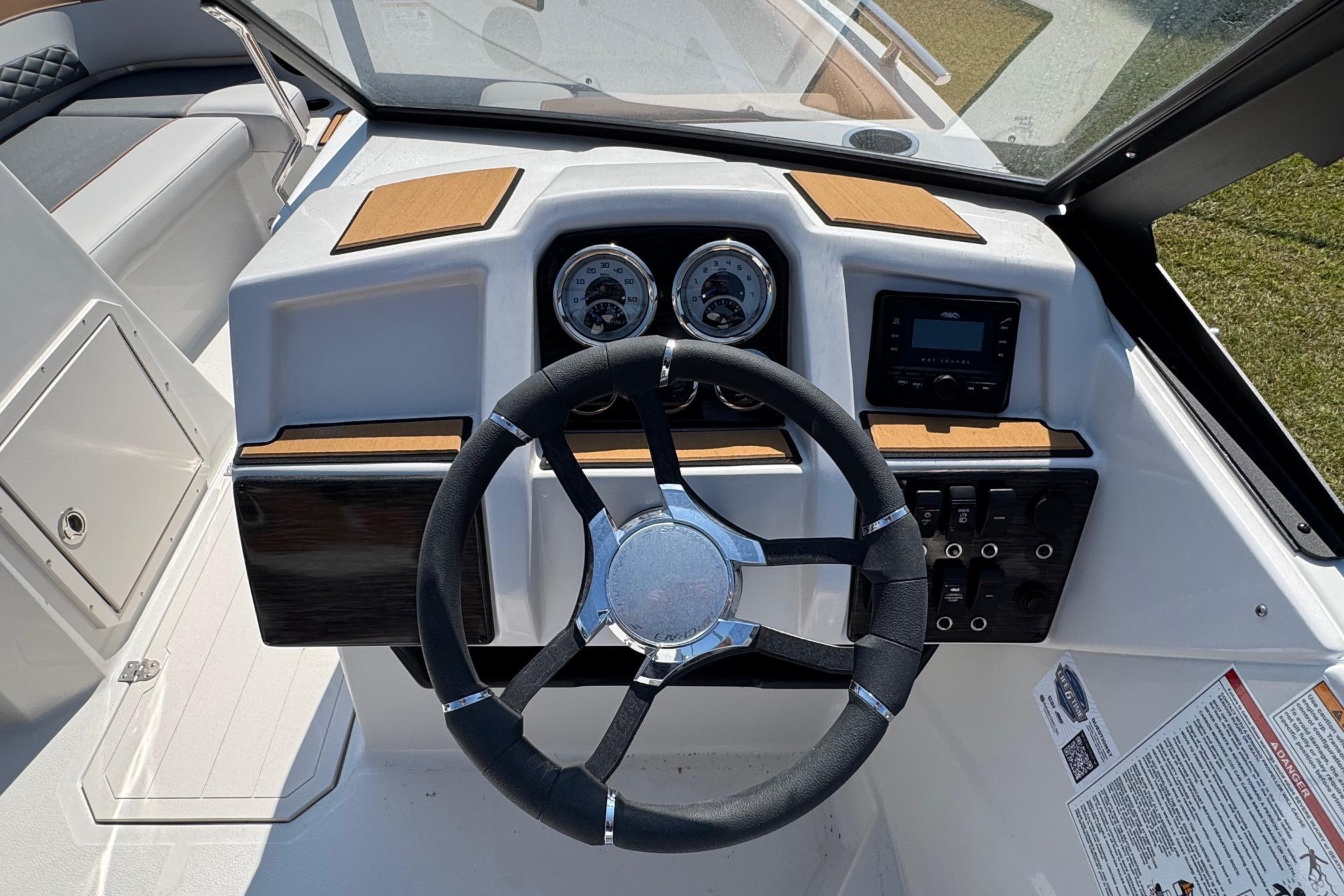2026 Starcraft SVX 190 OB boat dashboard with steering wheel and control panel.