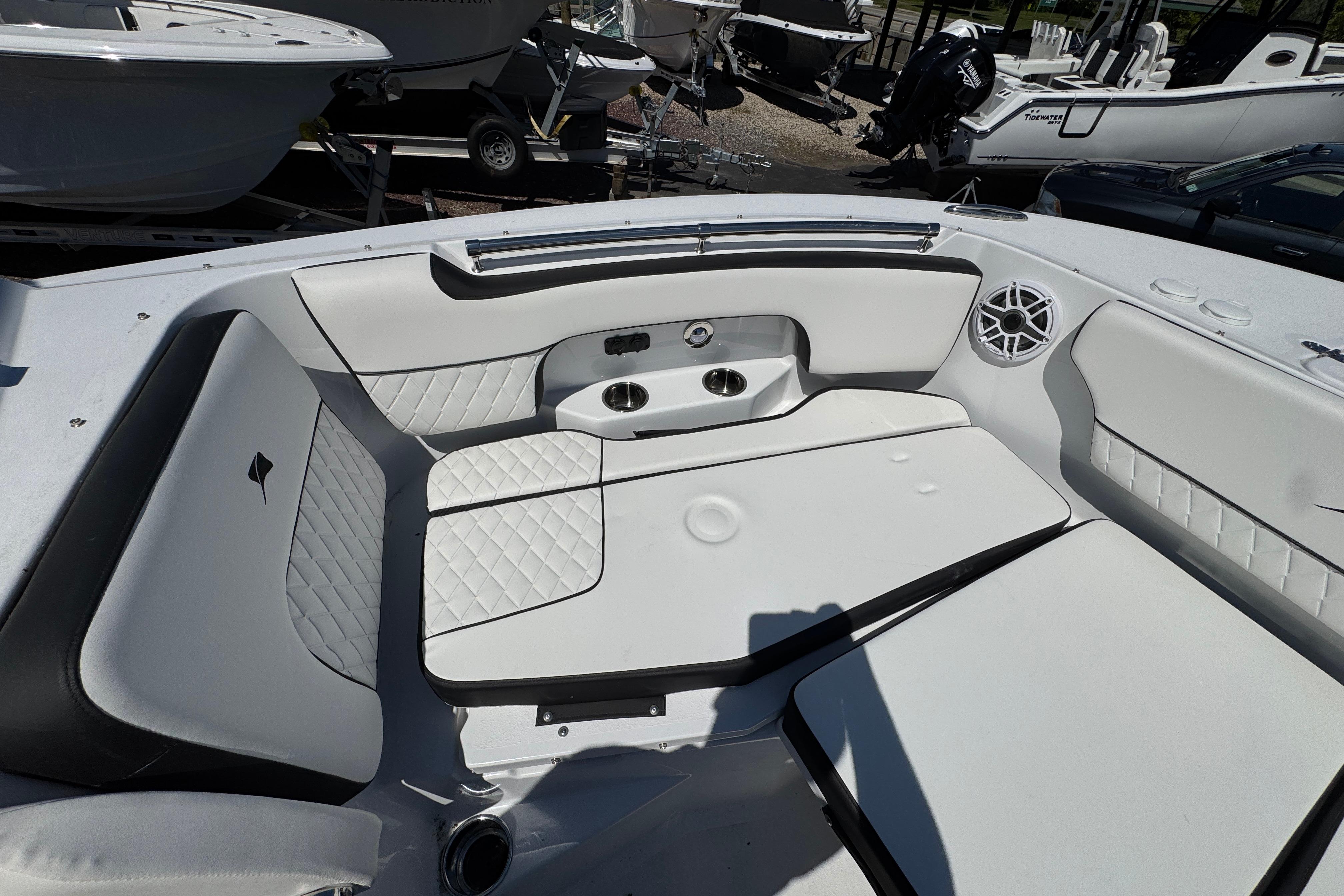 2026 Stingray 259 DC boat interior with white cushioned seating and cup holders.