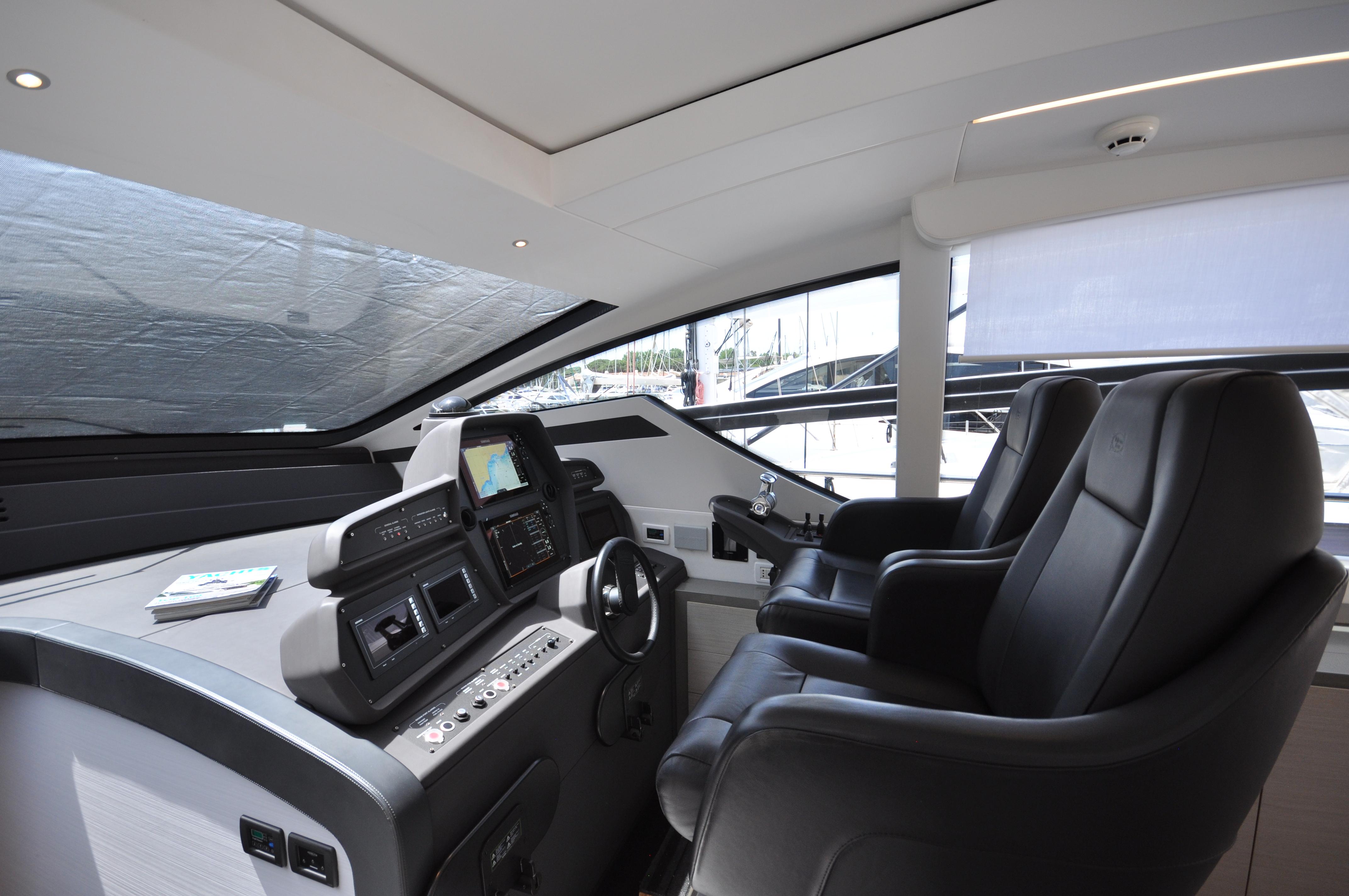Interior cockpit of 2020 Pershing 62' yacht with modern controls and leather seating.