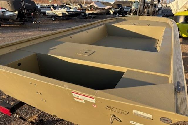 2026 Tracker Grizzly 1754 Utility boat in a storage yard, showcasing its spacious interior.