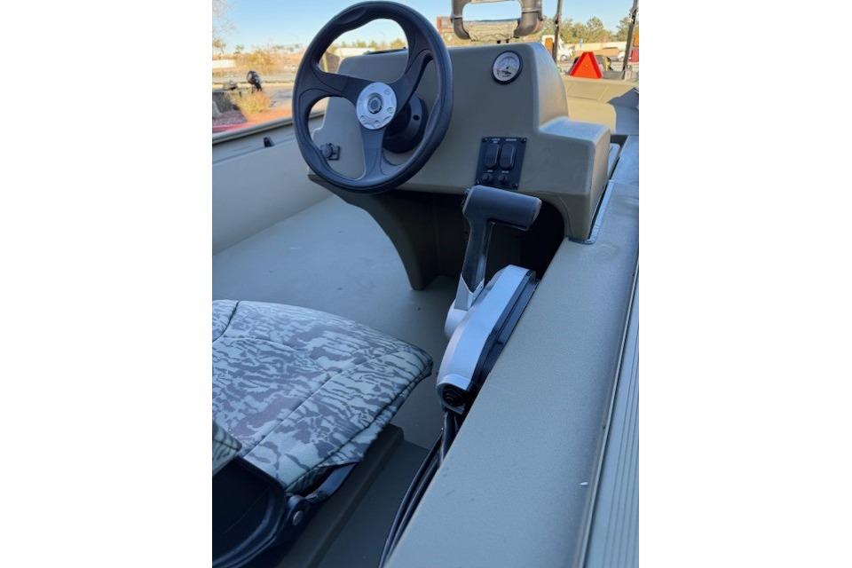 2026 Tracker Grizzly 1754 SC boat interior with steering wheel and camo seat.