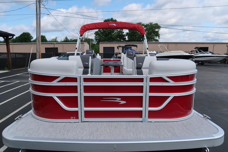 2026 Bennington S Quad Bench 20 SSR pontoon boat with red and white design in a parking lot.