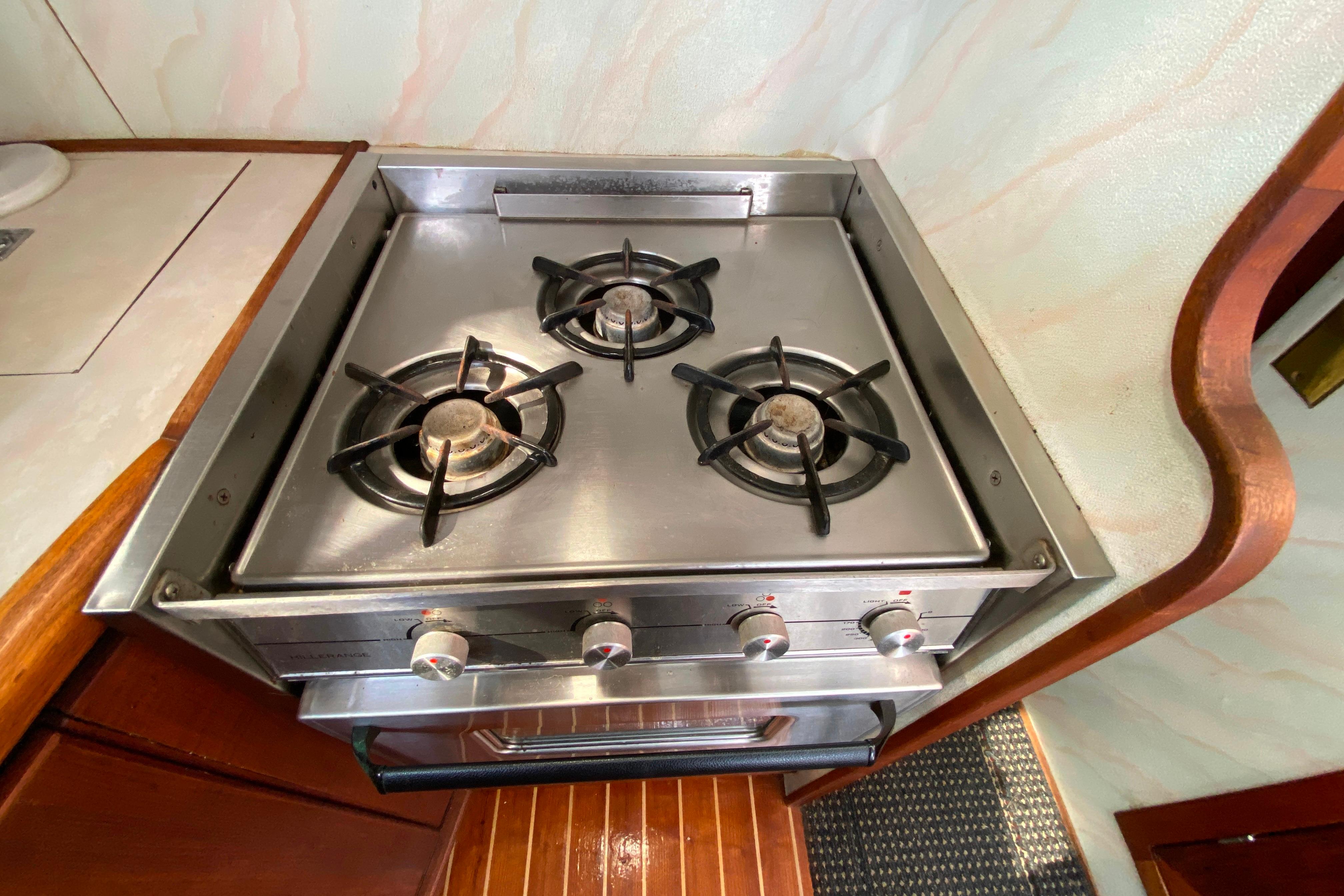 Stainless steel stove with three burners on 1989 Bayliner 3288 Motoryacht.