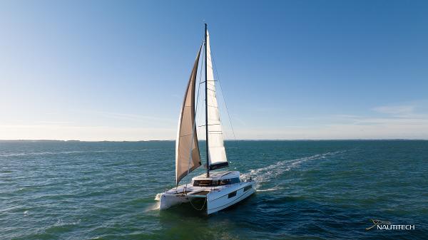 2025 Nautitech 48 Open catamaran sailing on open sea under clear blue sky.