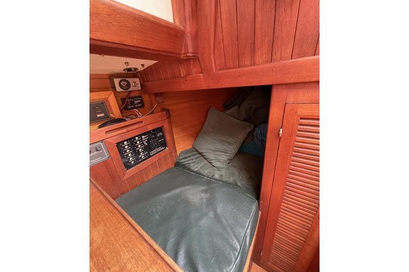Cozy cabin interior of 1980 Ta Shing Baba 30 sailboat with wooden paneling.