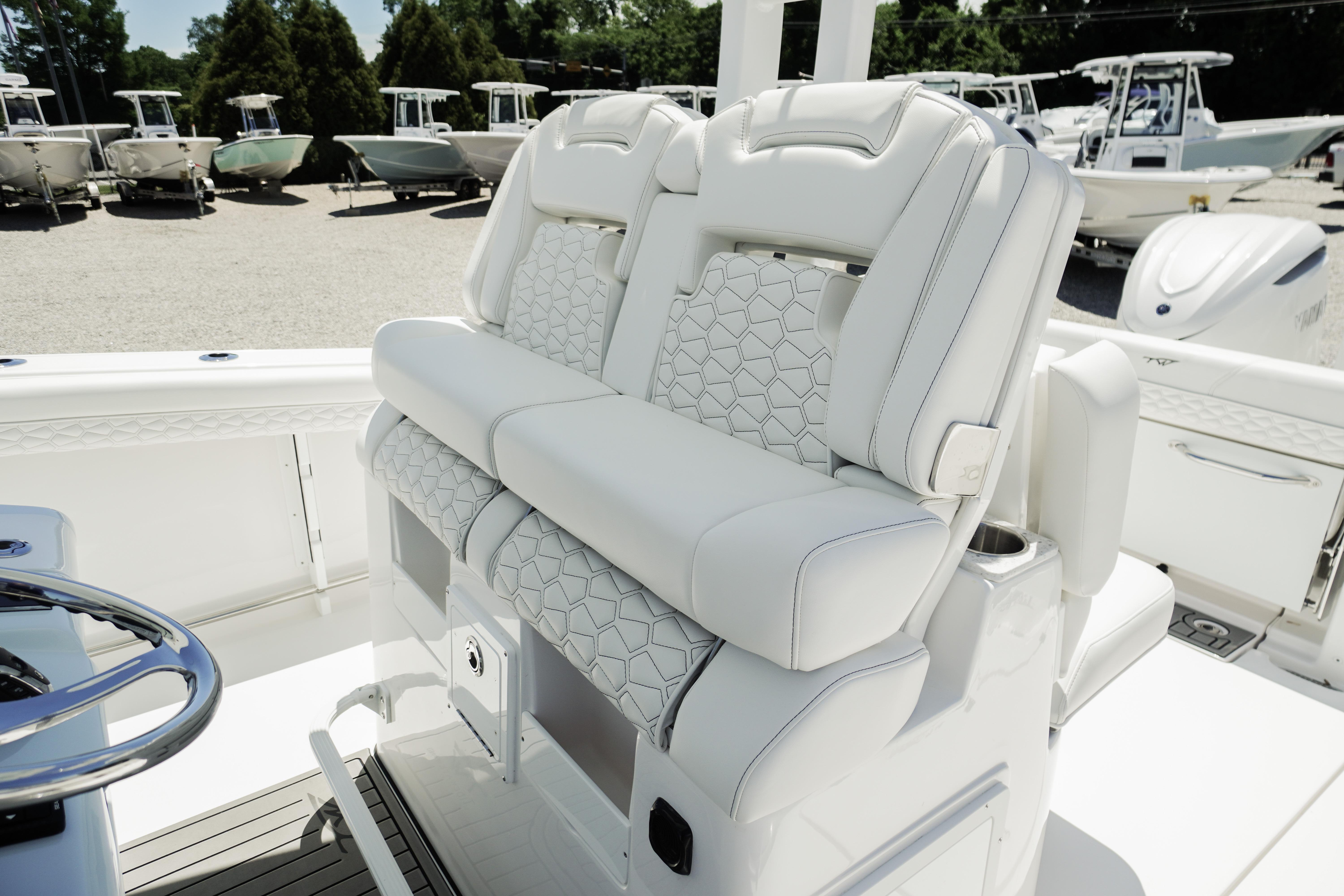Luxury seating on 2026 Tidewater 302 CC Adventure boat, featuring elegant white upholstery.