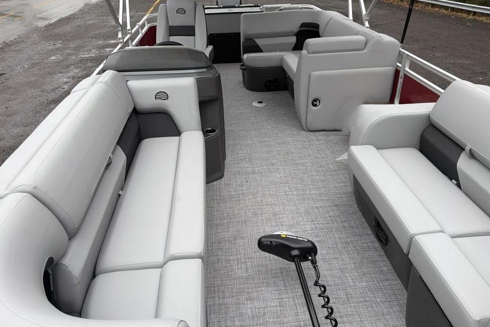2026 Sun Tracker SportFish 22 DLX pontoon boat interior with gray seating and spacious layout.