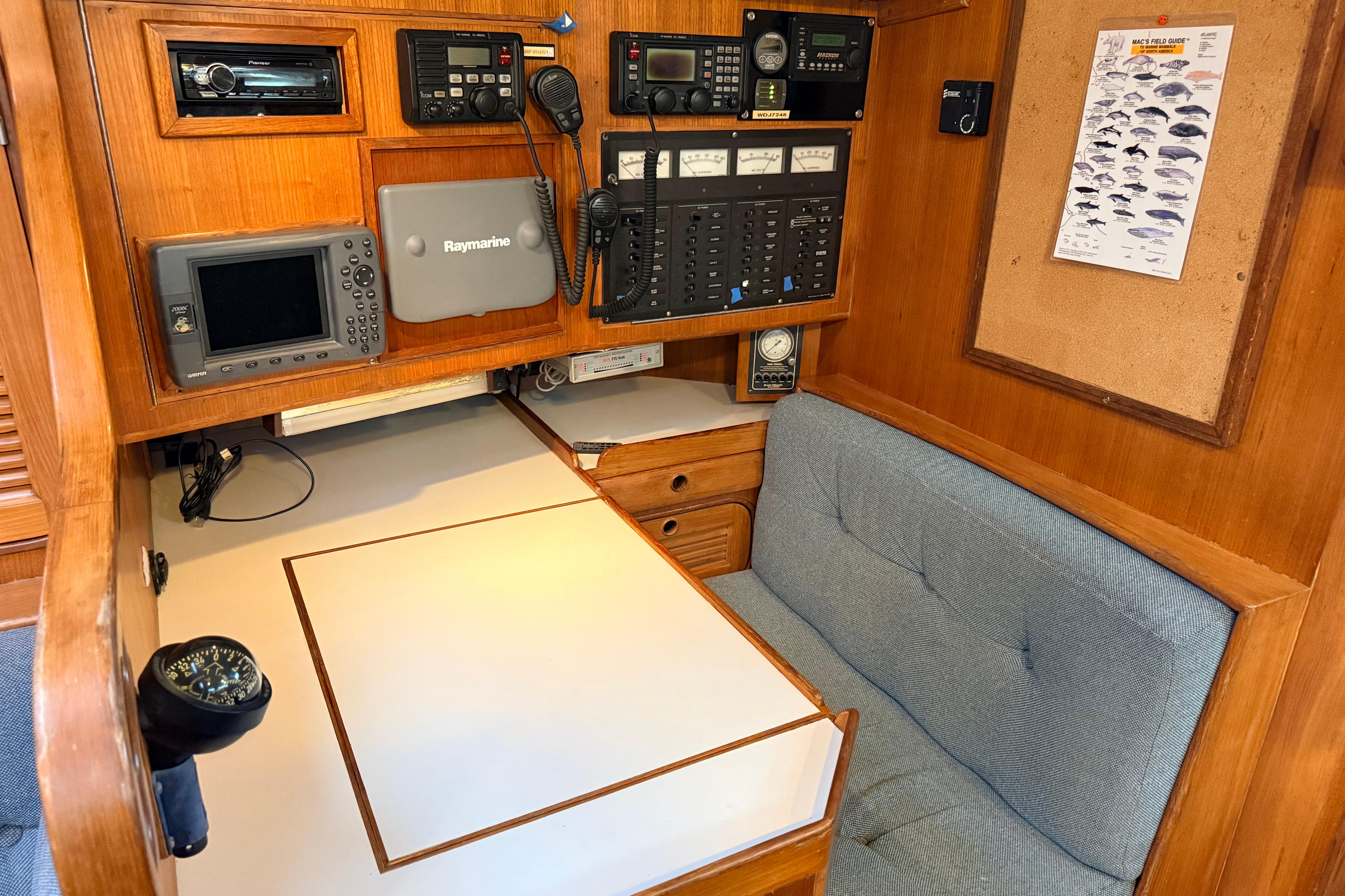 Navigation station of 1987 Norseman 400 yacht with electronic equipment and seating area.