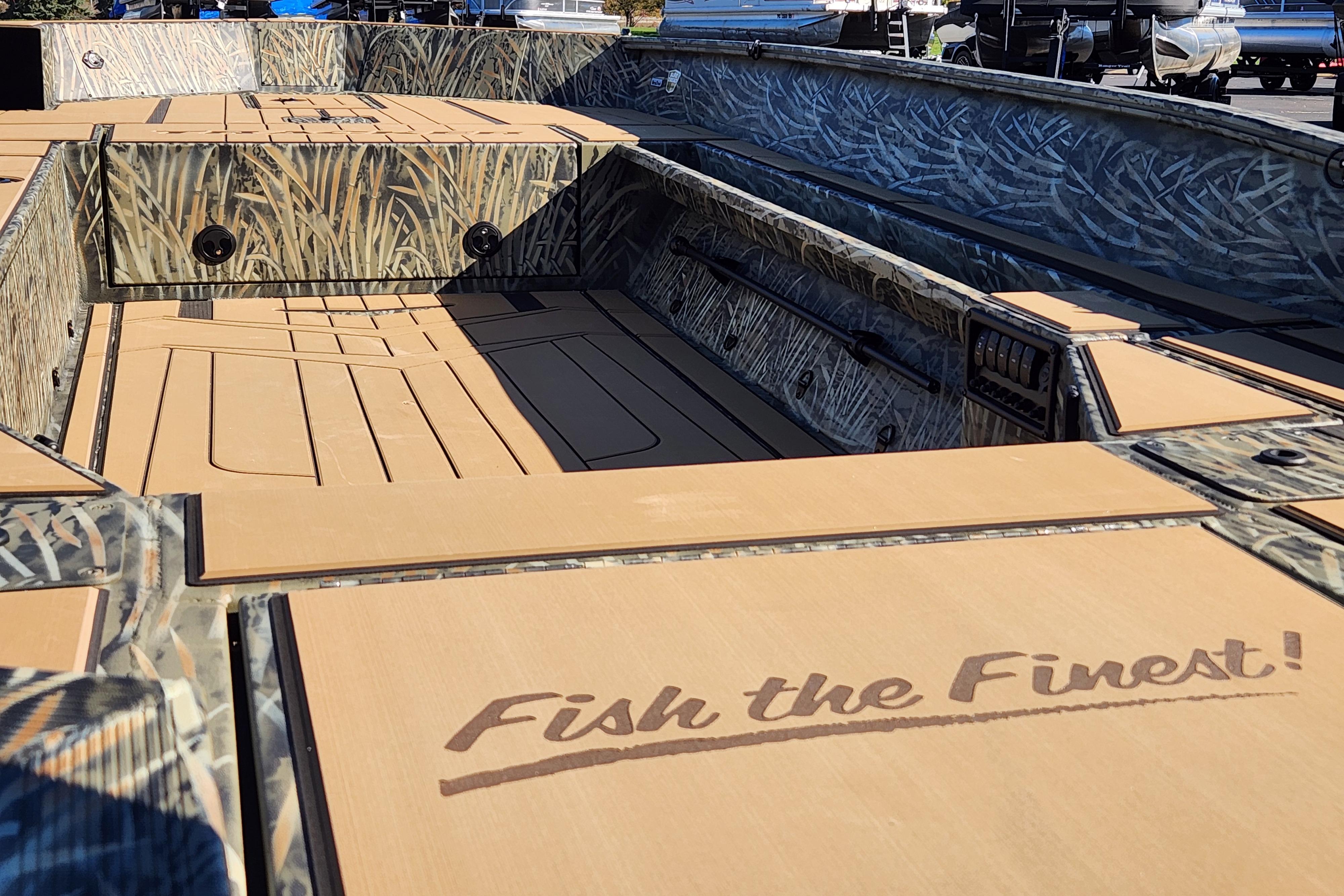 2026 Tracker Grizzly 1756 T Marsh boat interior with camo design and "Fish the Finest!" text.