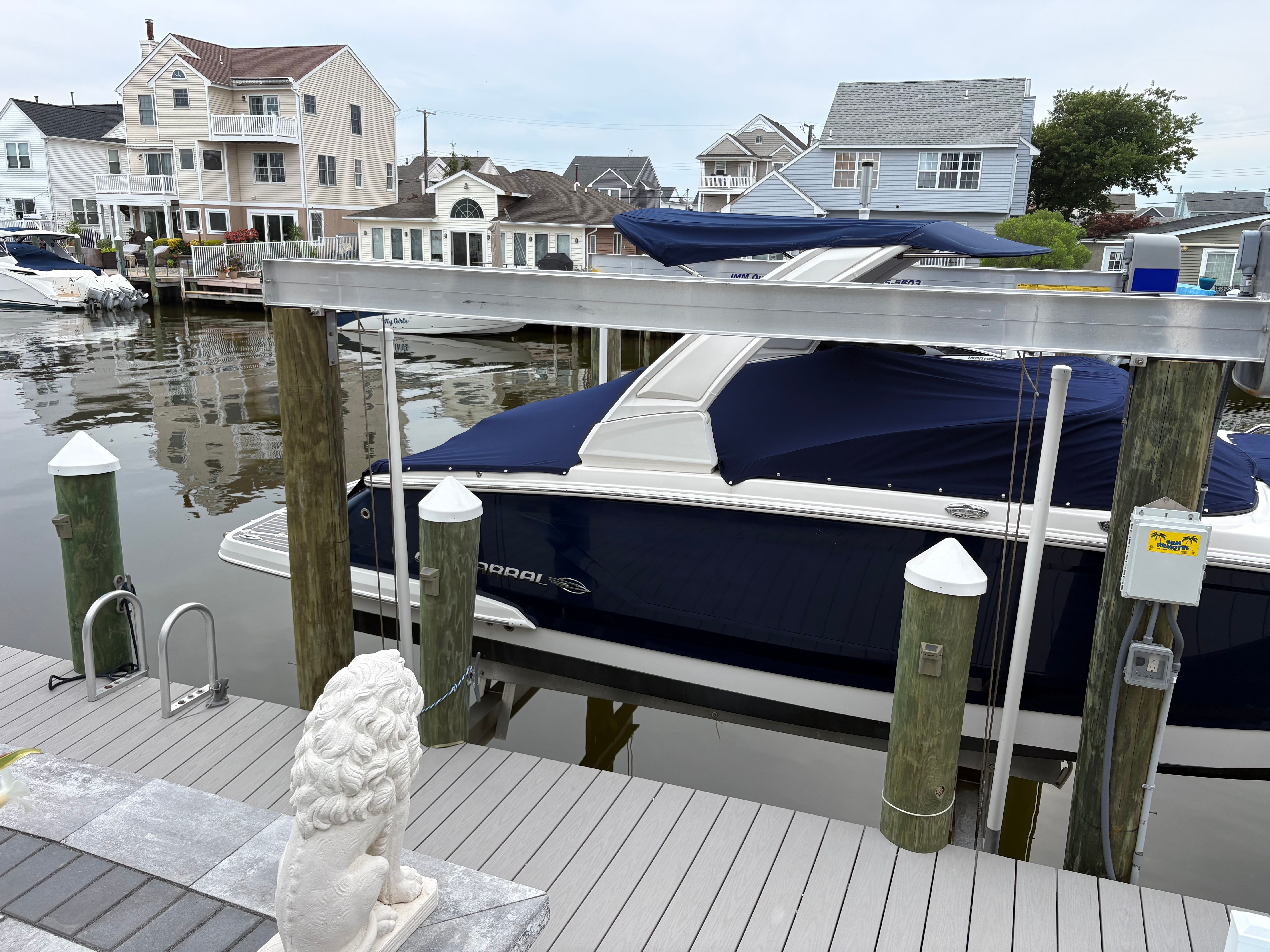 A 2019 Chaparral SSX277 boat docked in a calm residential area.
