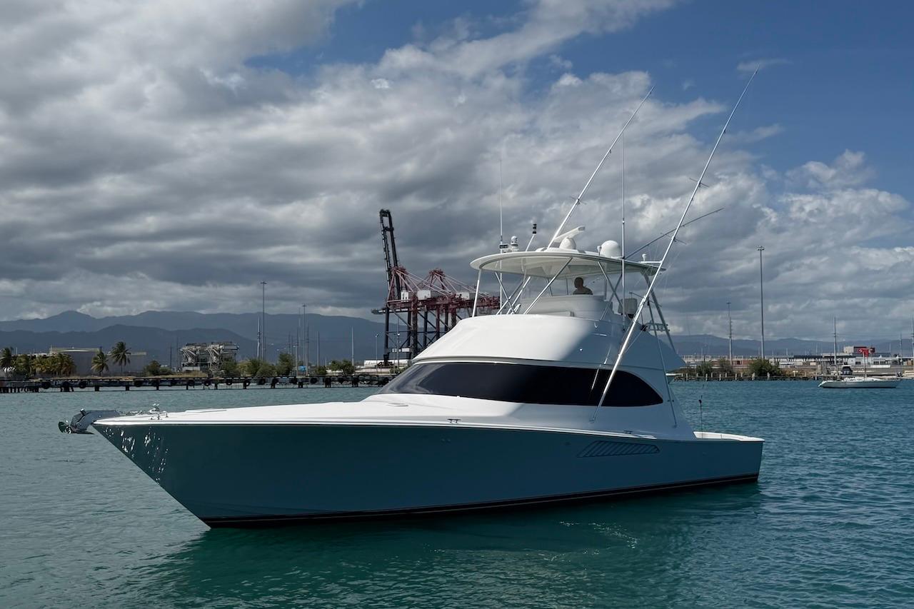 2012 Viking 50 Convertible yacht on calm waters under a cloudy sky.