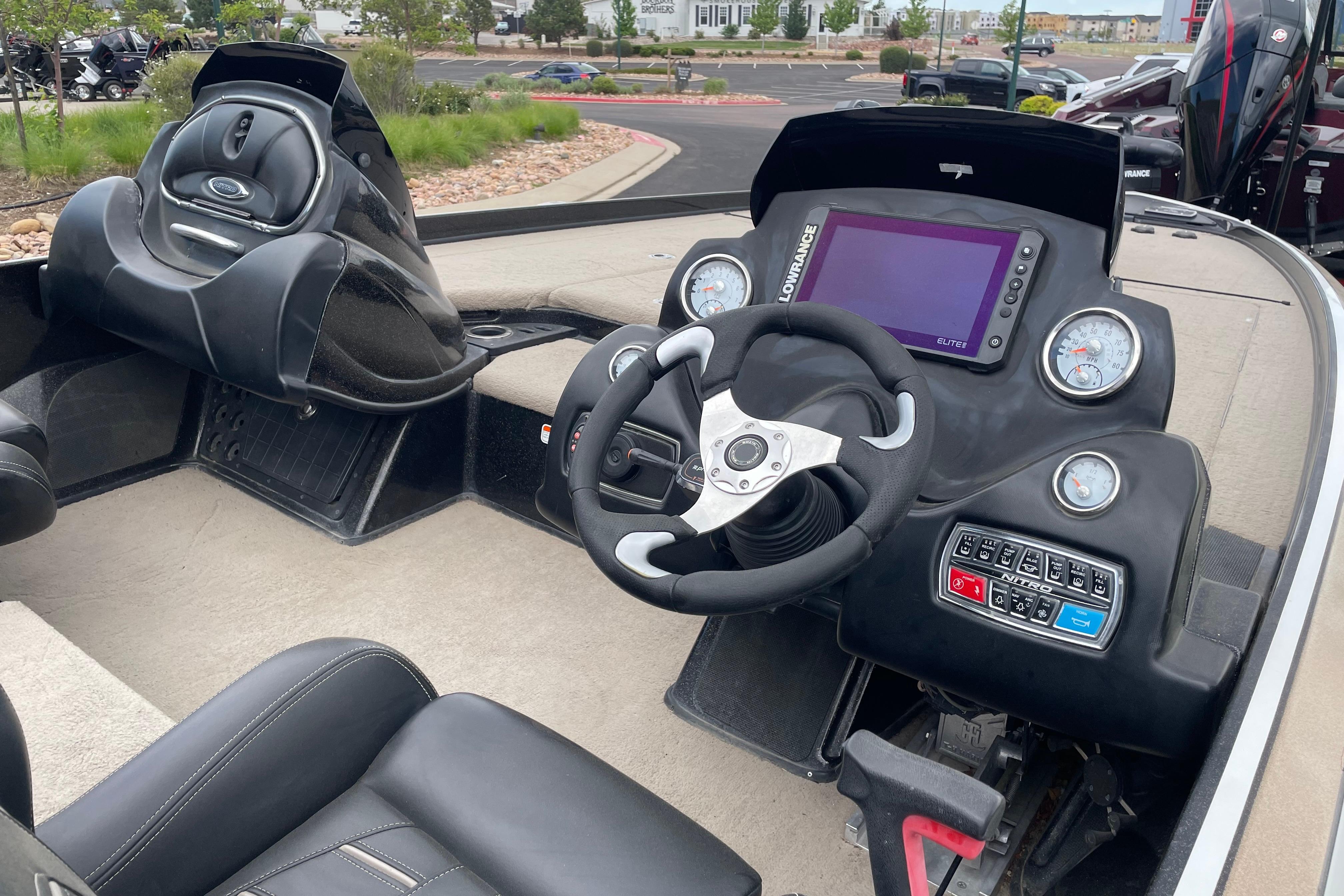 2016 Nitro Z21 boat cockpit with steering wheel, gauges, and control panel.