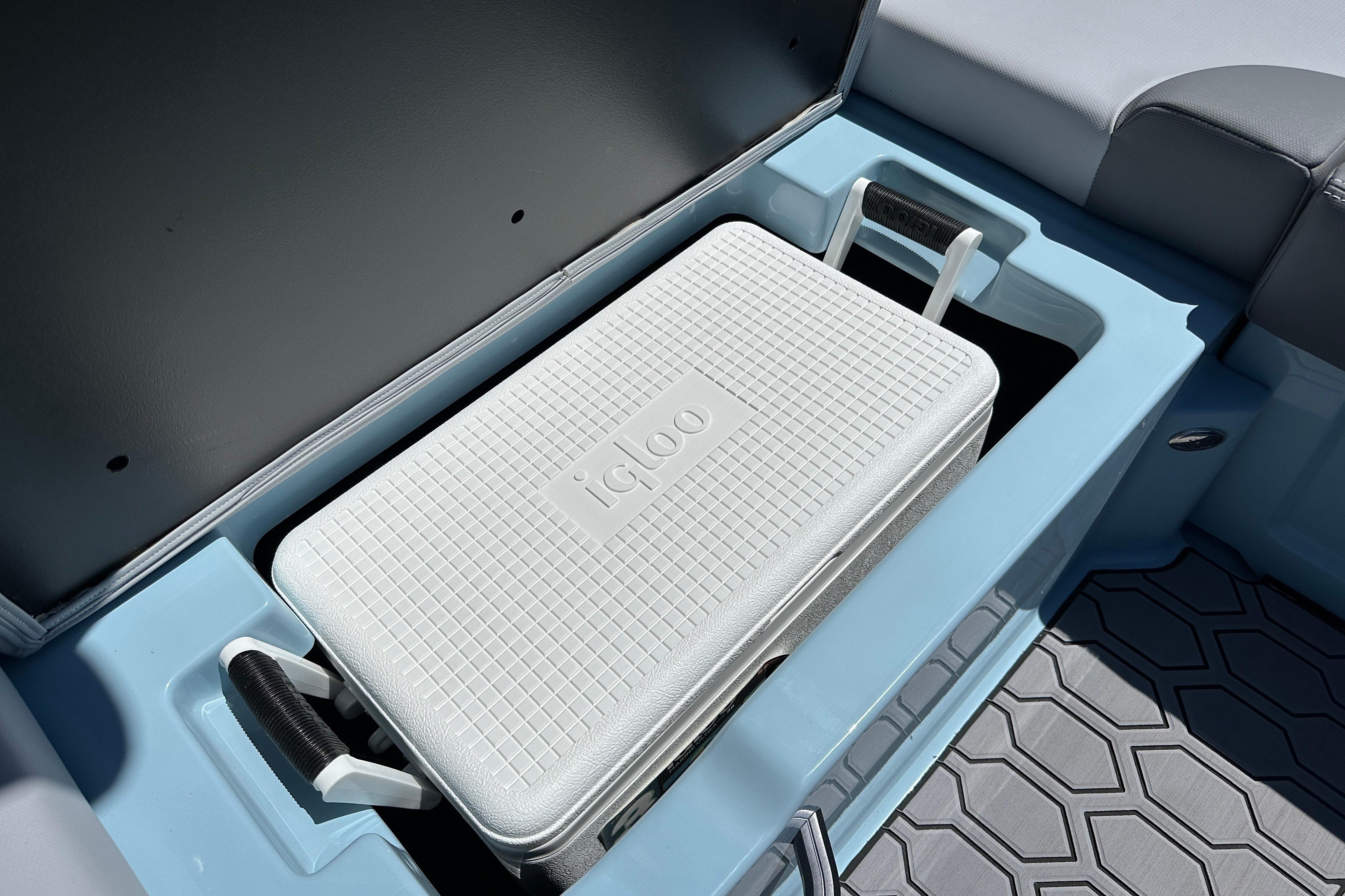 2023 MasterCraft NXT23 boat storage with Igloo cooler in compartment.
