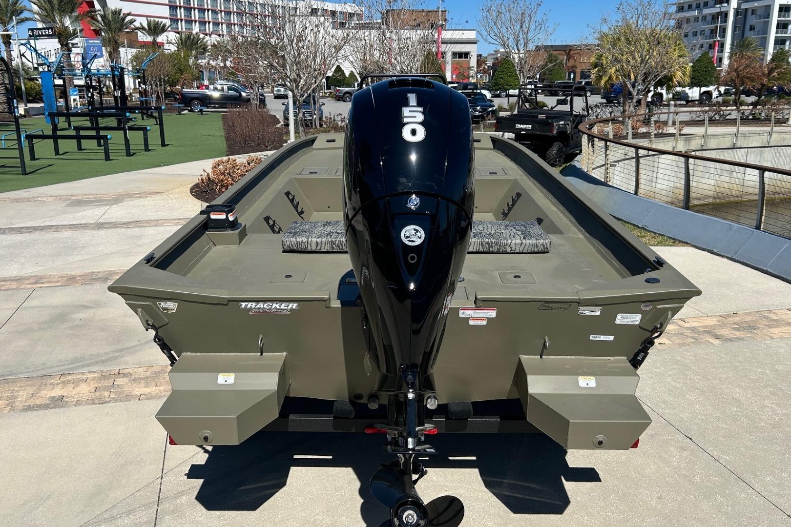 2026 Tracker Grizzly 2072 CC boat with 150 HP outboard motor, parked outdoors.