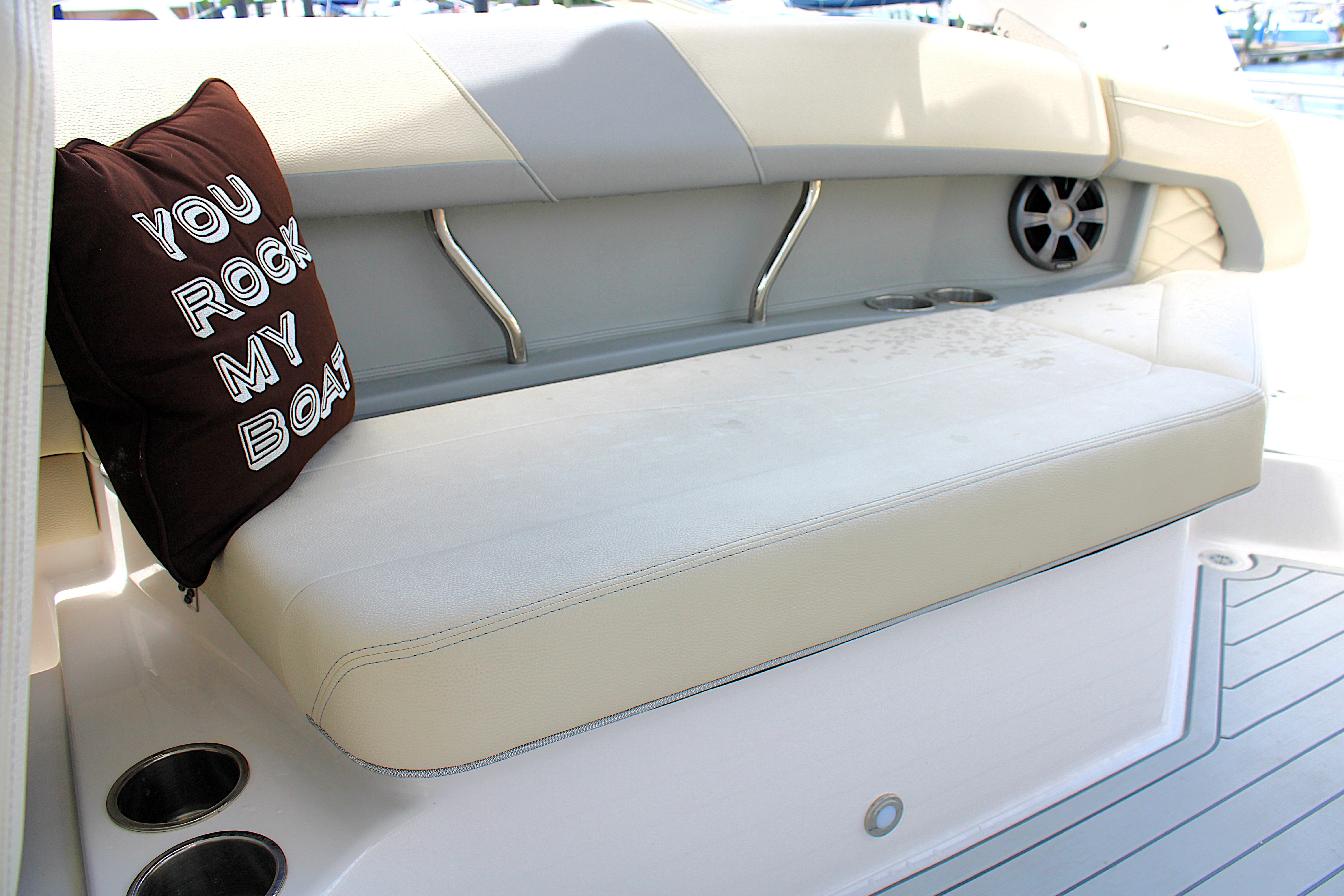 2021 Regal 26 OBX boat interior with cushioned seating and decorative pillow.