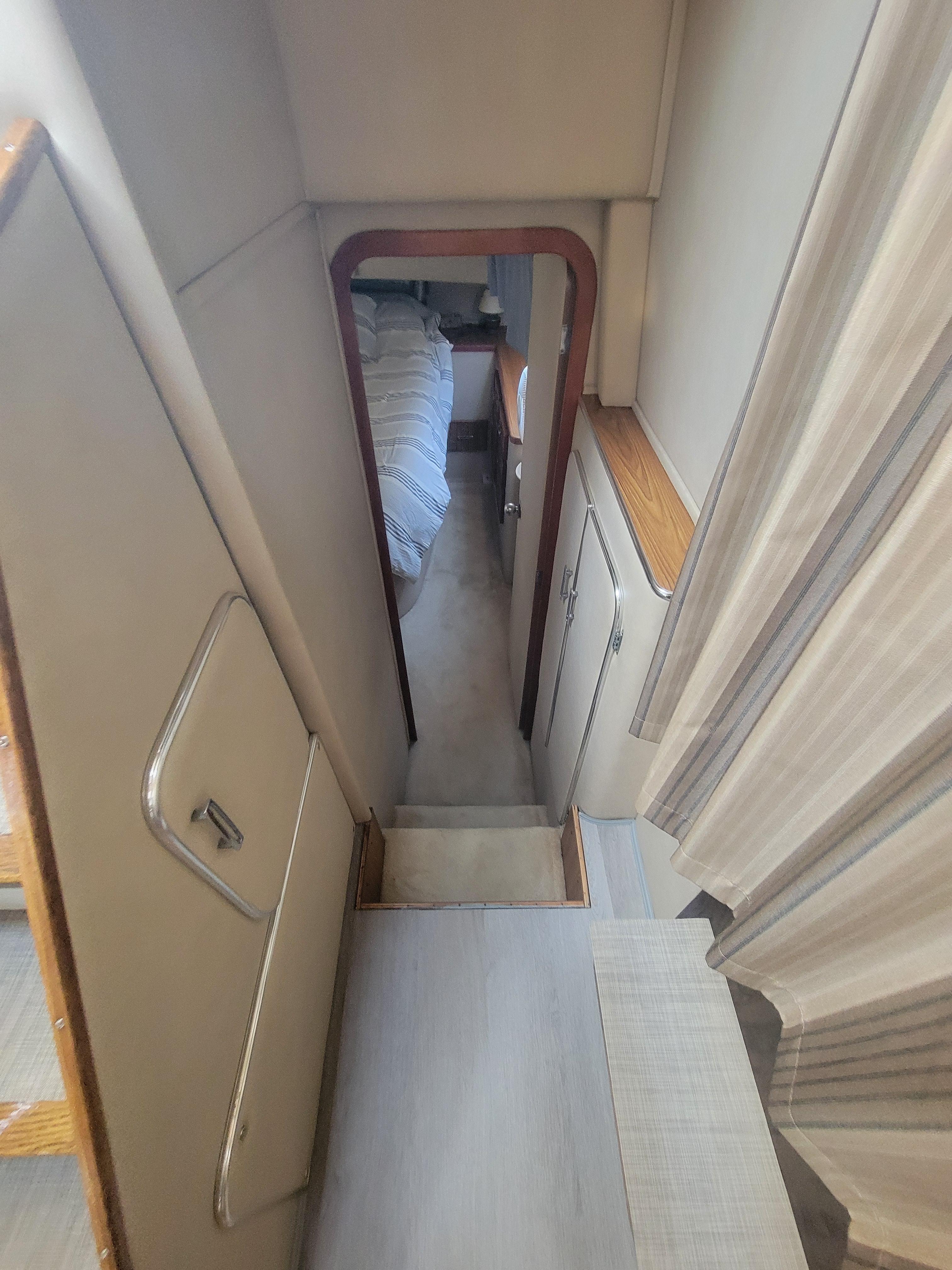 1986 Chris-Craft 381 Catalina interior with narrow passageway and visible bedroom.