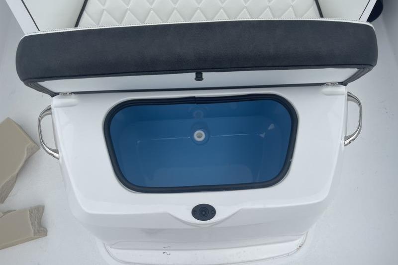 Open storage compartment on 2025 Stingray 173CC boat with cushioned seat.