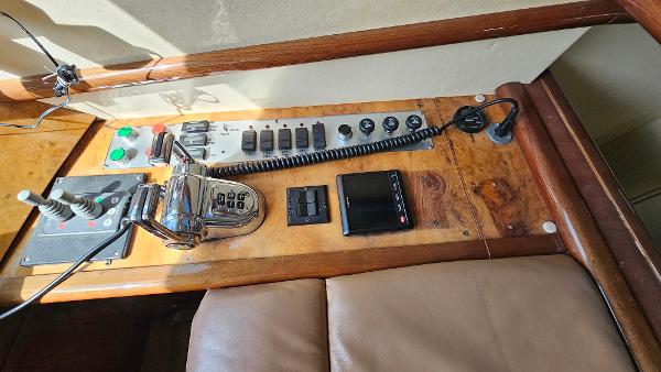 Control panel of a 2005 Neptunus 56 Flybridge yacht with various switches and levers.