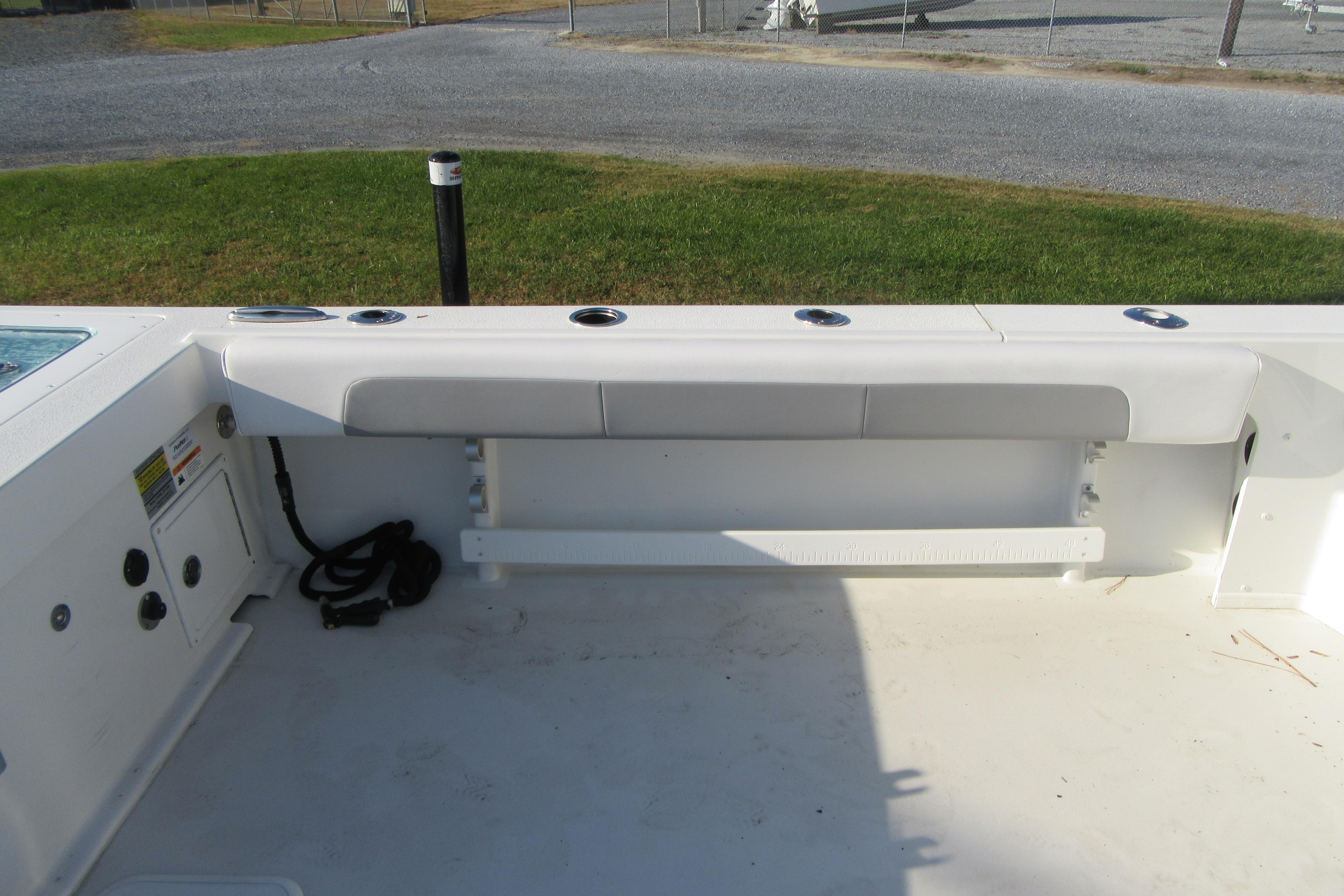 2024 Parker 2320 SL Sport Cabin boat interior with seating and rod holders.
