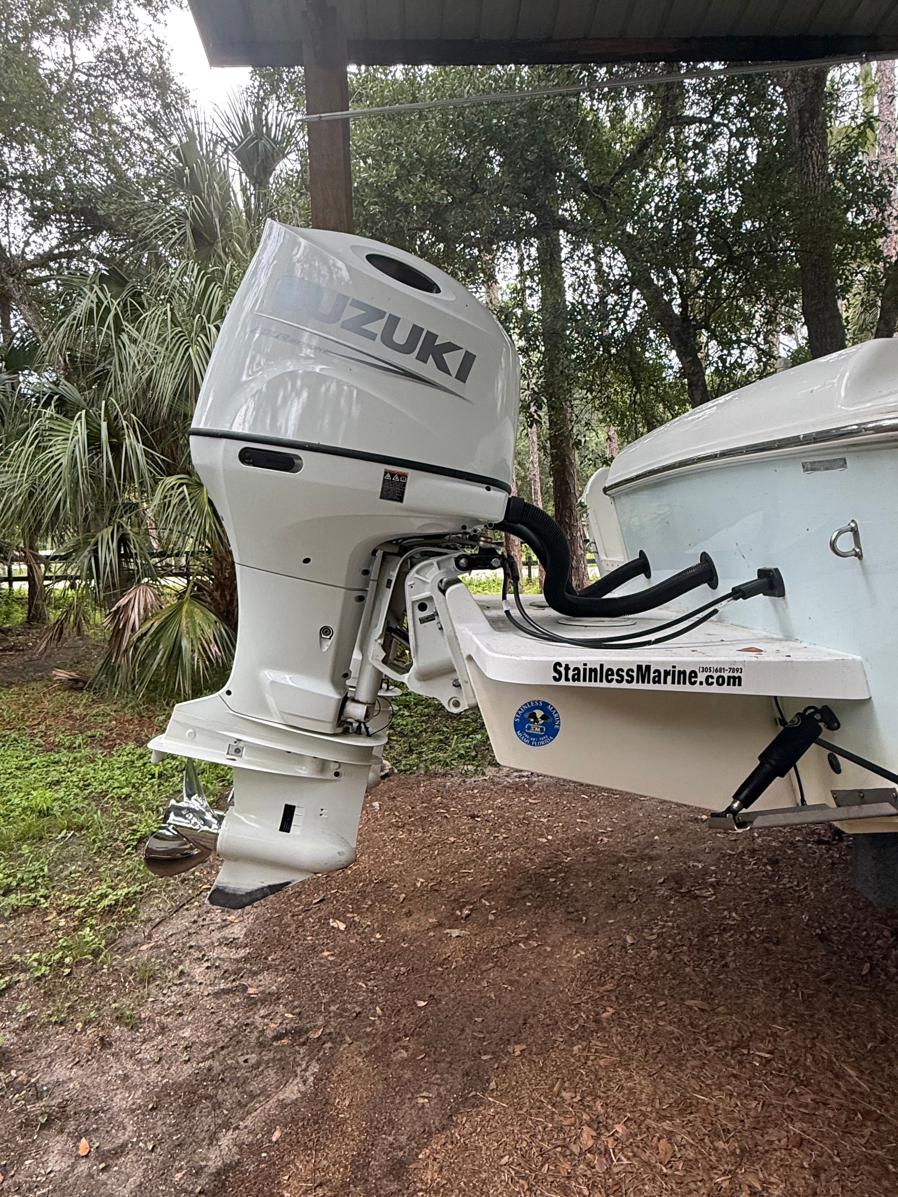 A Suzuki outboard motor on a 2021 Clearwater 2508 Center Console boat.