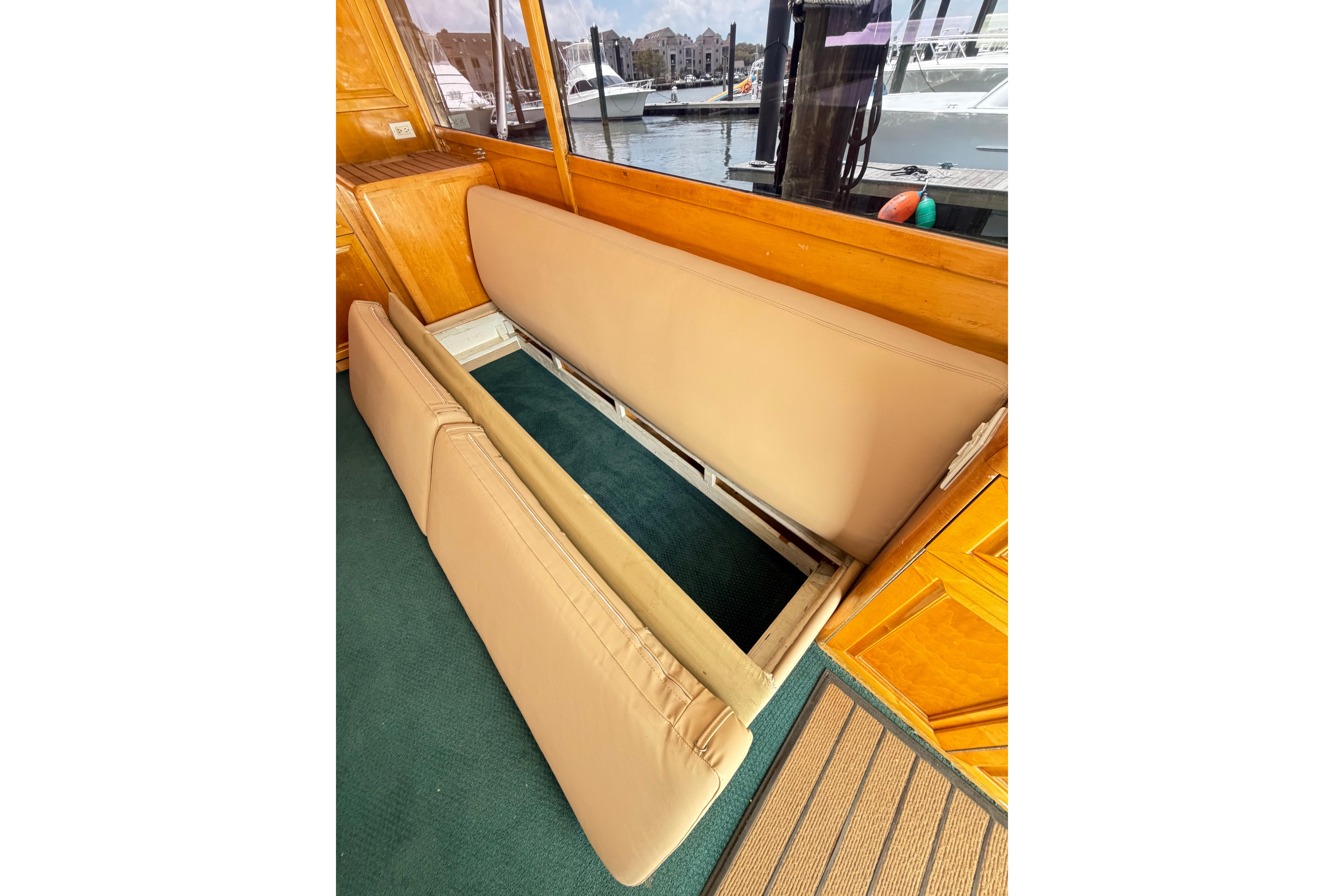1998 Blackwell Custom Carolina Sportfish interior with foldable beige seating and wooden accents.