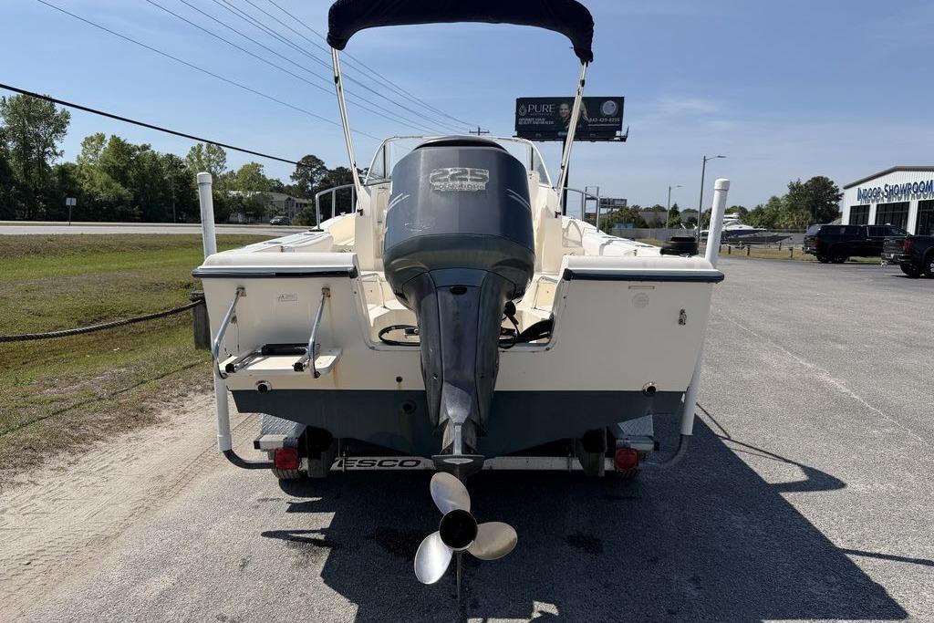 2003 Sea Hunt Victory 215 boat with outboard motor, parked on a trailer.
