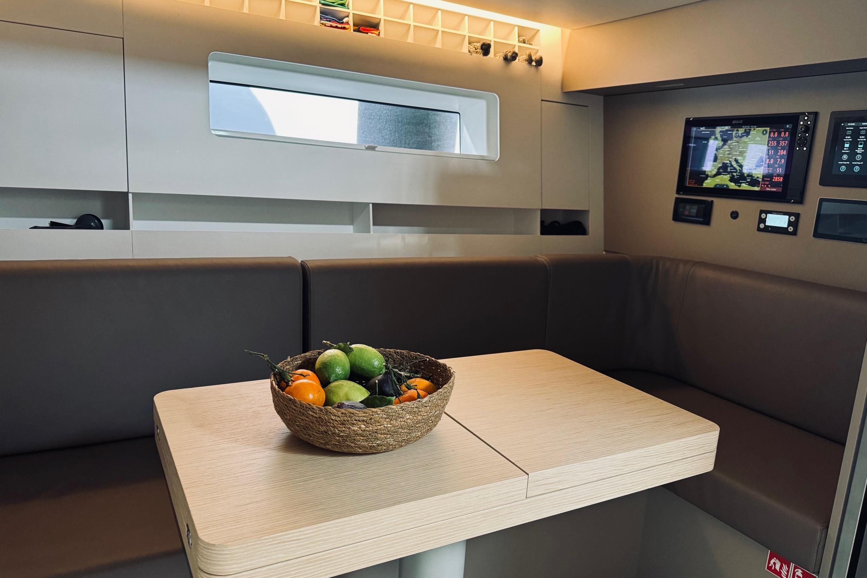 Modern interior of 2024 YYachts Y8 with fruit basket on table.
