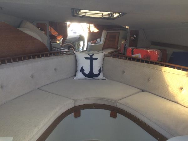 1987 Boston Whaler Cuddy Tower interior with anchor-themed pillow and cushioned seating.